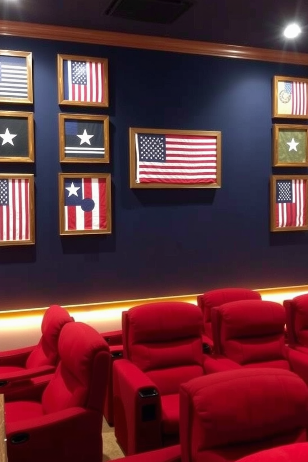 The wall art displays a collection of flags representing different branches of the military, framed in rustic wooden frames. The backdrop is a deep navy blue, enhancing the patriotic theme and creating a striking focal point in the home theater. The theater seating is arranged in a cozy layout, with plush recliners upholstered in red fabric for a comfortable viewing experience. Ambient lighting is installed along the base of the walls, casting a warm glow that complements the themed decor.