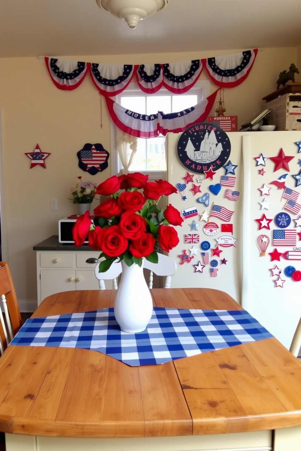 A cozy kitchen adorned with Memorial Day decorations. The walls are painted a soft cream color, and red, white, and blue bunting hangs above the window. A rustic wooden table is set with a blue and white checkered tablecloth, and a centerpiece of red roses in a white vase sits in the middle. Patriotic-themed fridge magnets in red, white, and blue hues form a collage on the refrigerator door, depicting stars, stripes, and various Memorial Day symbols.