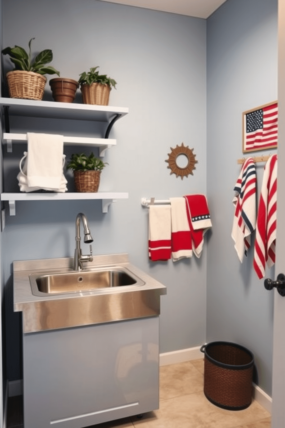 A stylish laundry room featuring a utility sink with a sleek stainless steel finish. The walls are painted in a soft blue hue, and the floor is adorned with light gray tiles for a modern touch. Incorporate open shelving above the utility sink to display decorative baskets and plants. A cheerful Memorial Day theme is introduced with red, white, and blue accents through towels and wall art.