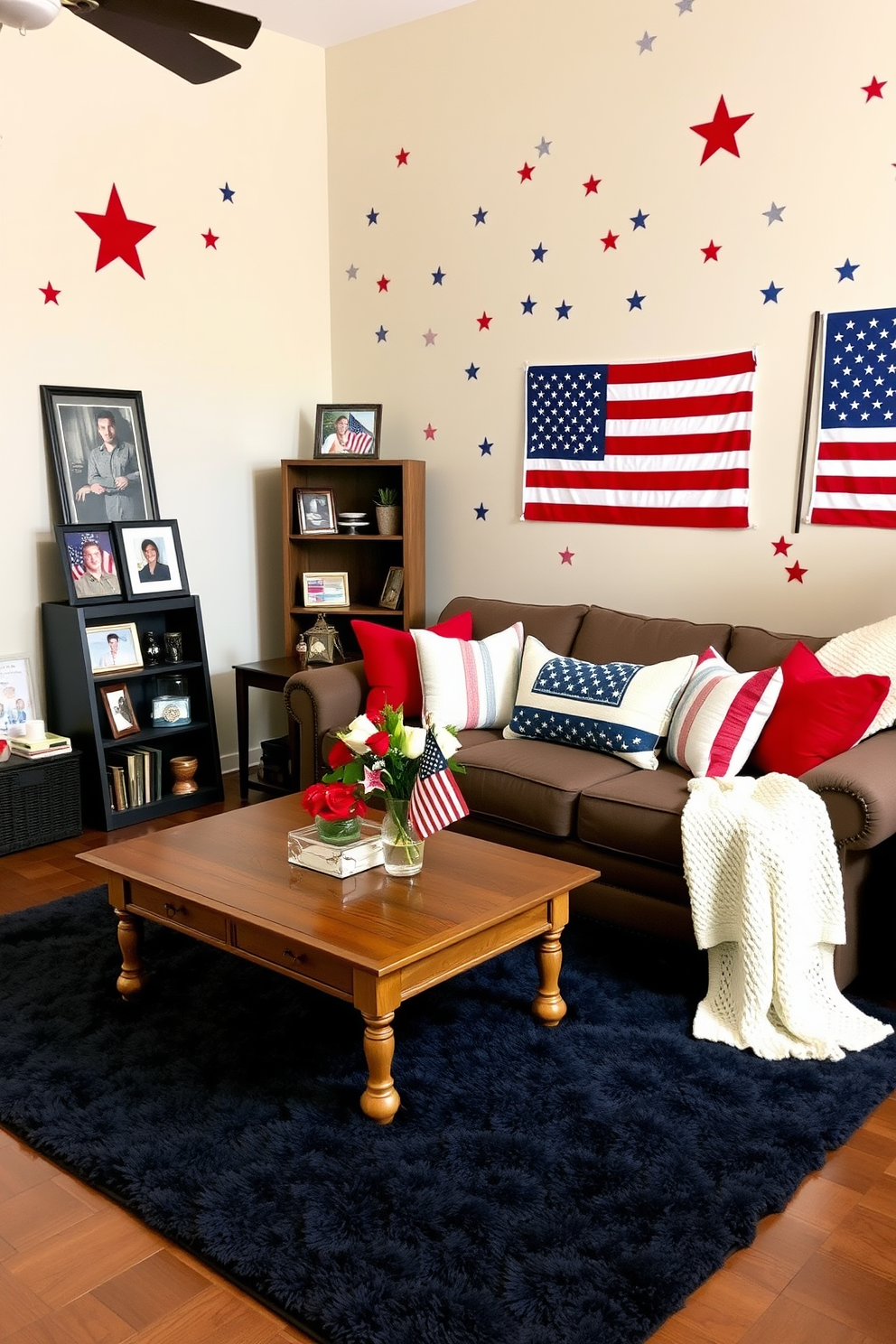 A cozy living room decorated for Memorial Day. The walls feature patriotic-themed wall decals, including stars, stripes, and the American flag. A large, comfortable sofa with red, white, and blue throw pillows sits in the center of the room. A wooden coffee table is adorned with a vase of fresh flowers in patriotic colors and a small American flag centerpiece. To the left of the sofa, a tall bookshelf displays framed photos of family members who have served in the military. The floor is covered with a plush, navy blue rug, and a white knitted throw blanket is draped over the back of the sofa.