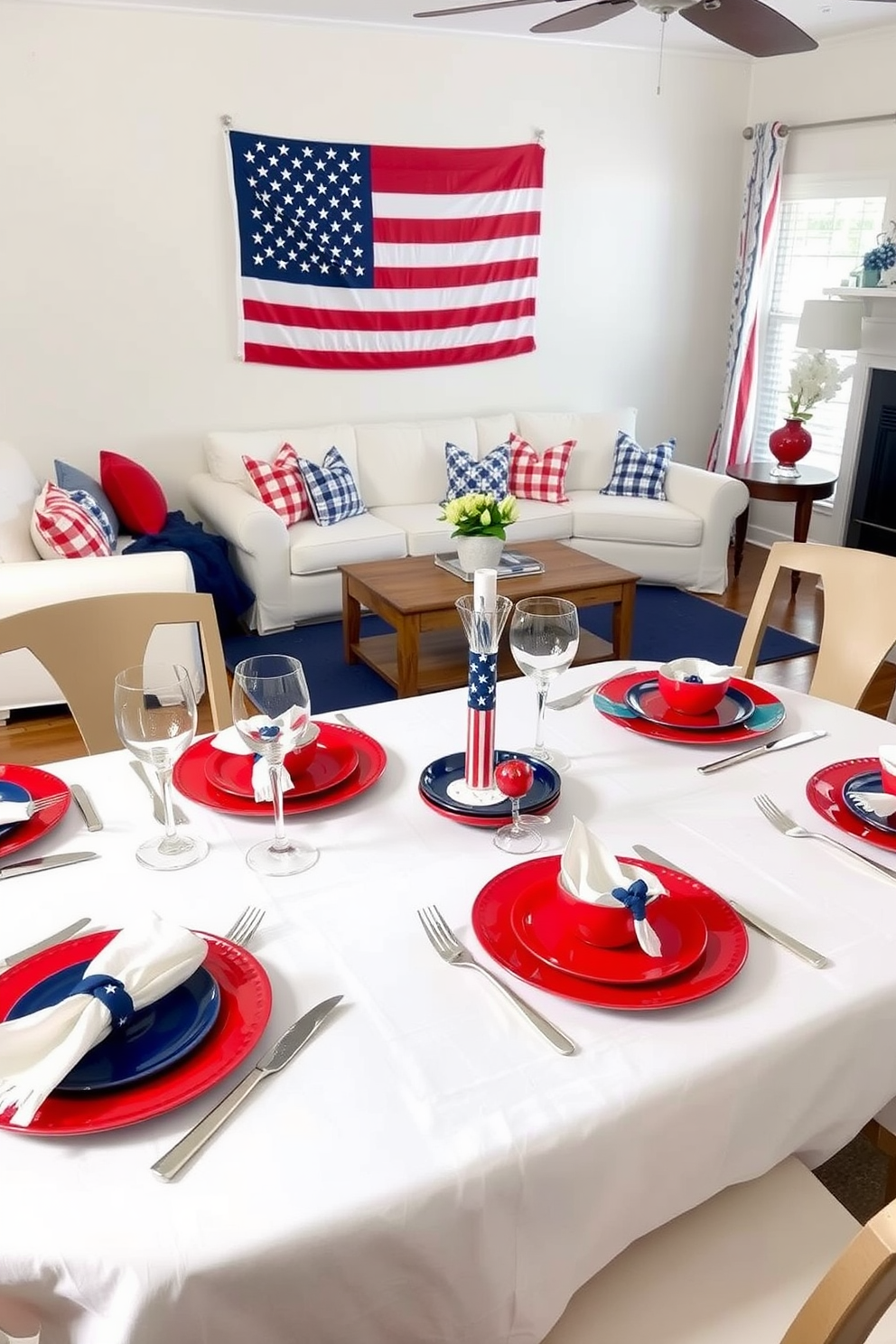 A dining table set with red, white, and blue tableware. The table is covered with a white linen tablecloth, and each place setting includes a red plate, a blue salad plate, and a white napkin neatly folded on top, with silver cutlery and crystal glassware completing the ensemble. A Memorial Day living room decorated with patriotic flair. The room features a plush white sofa adorned with red and blue throw pillows, a navy blue area rug under a wooden coffee table, and a large American flag hanging proudly on the wall.