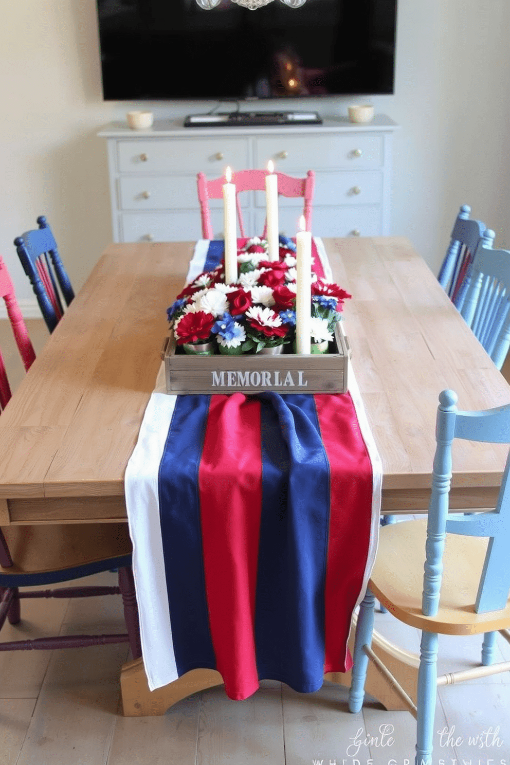 A festive dining table adorned with a red white and blue table runner that drapes elegantly across the length of the table. Surrounding the table are mismatched vintage chairs, each painted in patriotic colors to enhance the Memorial Day theme. The centerpiece features a collection of small potted flowers in red, white, and blue hues, arranged in a rustic wooden box. Soft white candles are placed at intervals along the table, casting a warm glow and creating an inviting atmosphere for guests.