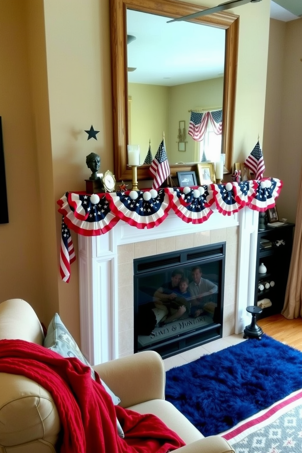 A cozy living room setting. The mantel is adorned with layered garlands of stars and stripes, creating a festive Memorial Day atmosphere. Above the mantel, a large mirror with a rustic wooden frame reflects the room. On the mantel itself, there are small American flags, candles, and a few framed family photos. The walls are painted in a soft beige, and the floor is covered with a plush navy blue rug. A comfortable armchair with a red throw blanket is placed near the fireplace, adding to the patriotic decor.