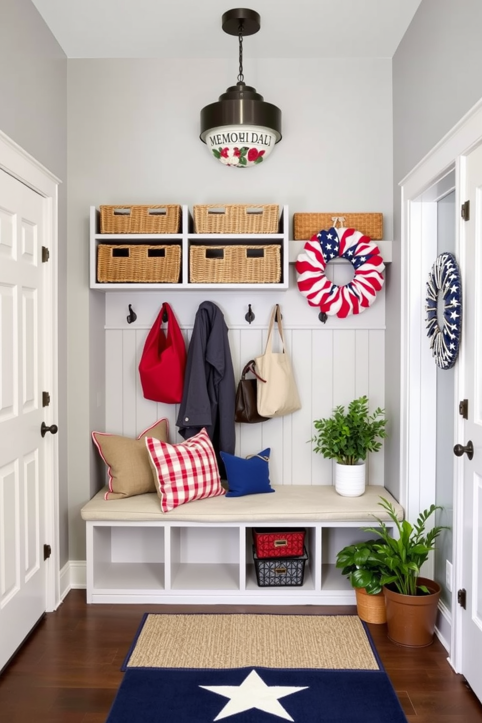 A stylish mudroom featuring organized shoe storage with woven baskets neatly arranged on shelves. The walls are painted a soft gray, and a bench with plush cushions sits below a row of hooks for coats and bags. Decorative elements for Memorial Day include red white and blue accents such as throw pillows and a festive wreath on the door. Potted plants add a touch of greenery, while a small rug with a star pattern welcomes guests into the space.