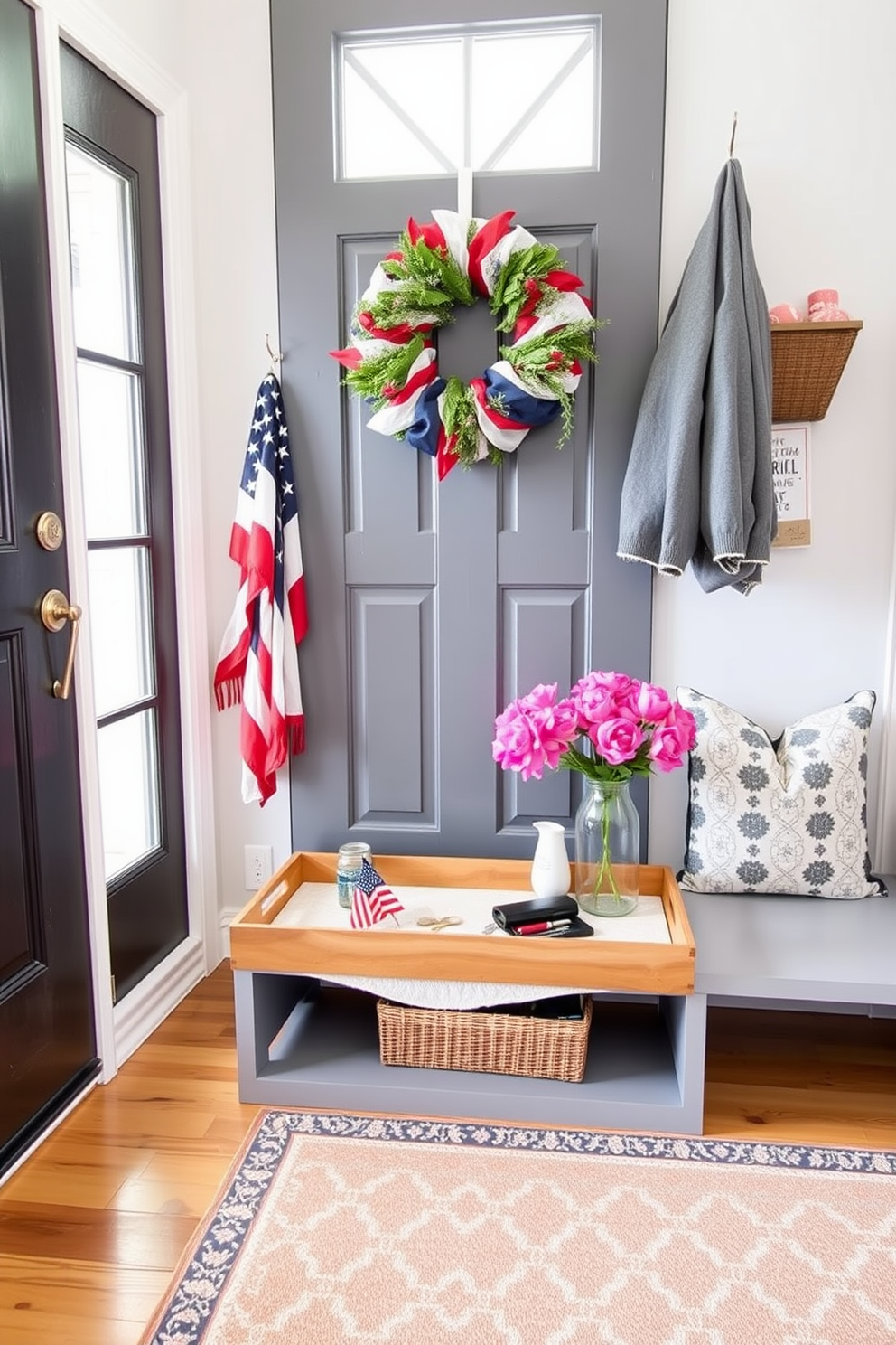 A stylish mudroom featuring a decorative tray for keys and essentials. The tray is crafted from natural wood and adorned with a soft, textured fabric underneath, providing a chic and functional touch. For Memorial Day, the mudroom is decorated with red, white, and blue accents. A festive wreath hangs on the door, and a patterned rug adds a welcoming pop of color to the space.