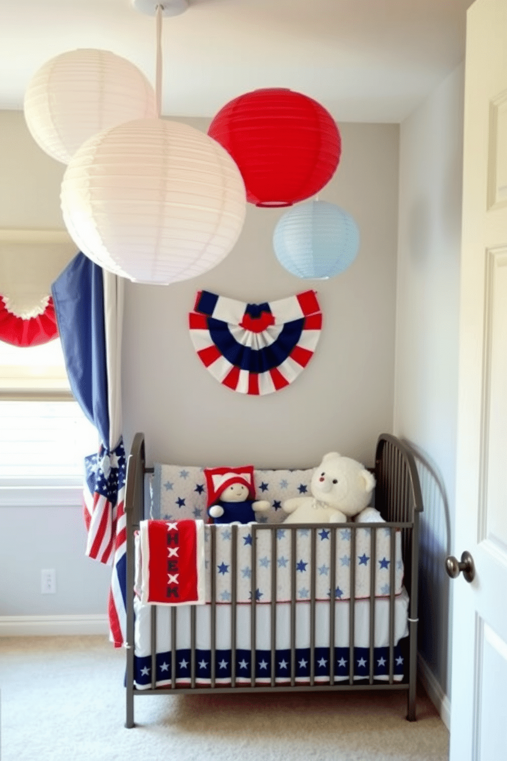 A charming nursery decorated for Memorial Day features red white and blue paper lanterns hanging from the ceiling. The walls are painted in a soft pastel shade, and a cozy crib is adorned with a patriotic quilt and plush toys.