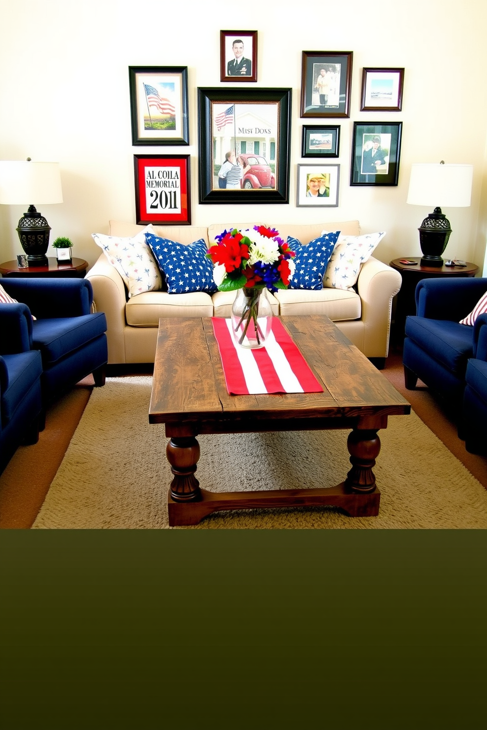 A cozy small living room setup. A red and white striped table runner adorns a rustic wooden coffee table, creating a vibrant focal point in the center of the room. The surrounding furniture includes a plush beige sofa with patriotic-themed cushions and a pair of navy blue armchairs. On the wall behind the sofa, a gallery of framed Americana art adds a celebratory touch. The floor is covered with a soft, neutral-toned rug, and a vase with fresh red, white, and blue flowers sits atop the coffee table, completing the Memorial Day decor.