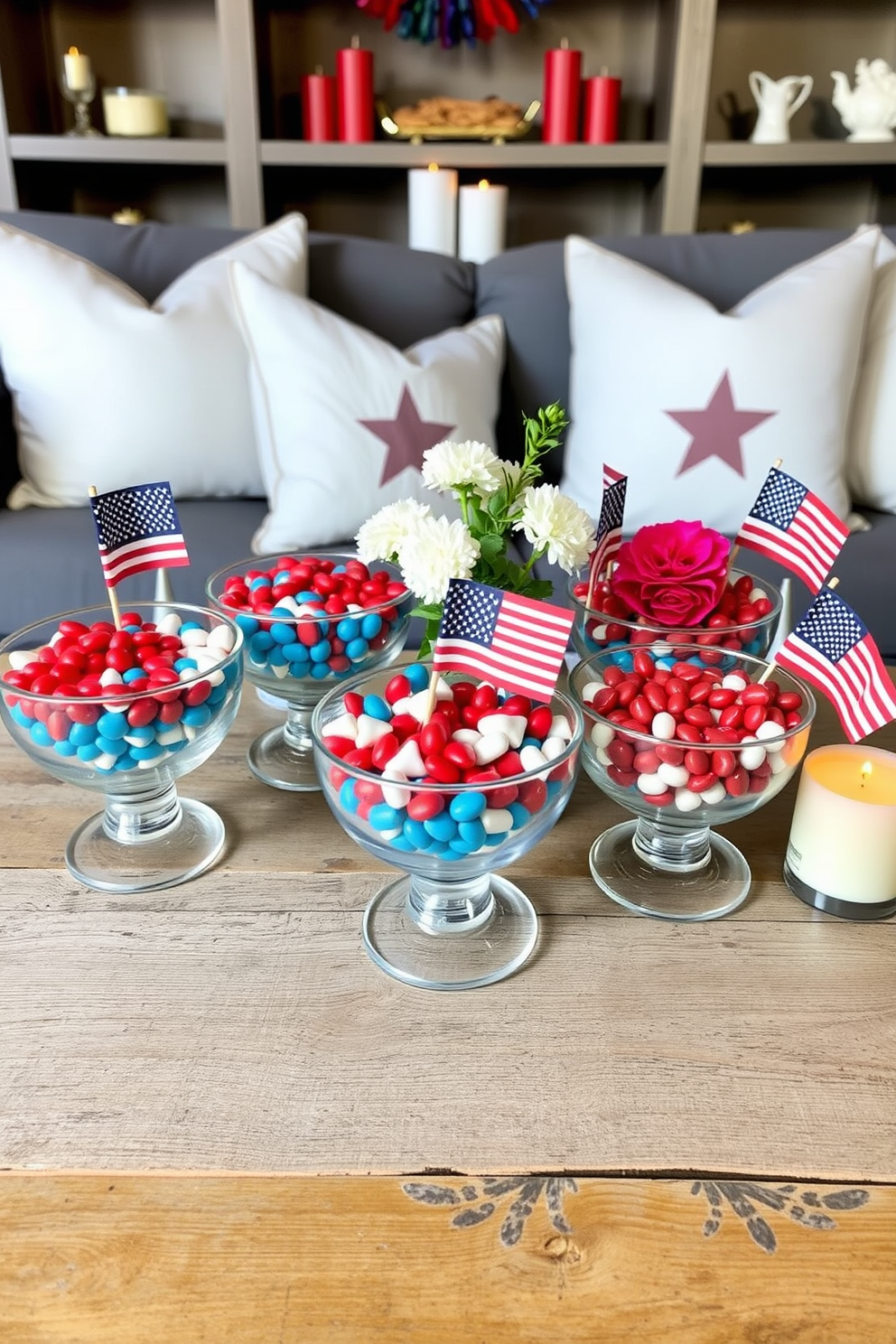 A collection of decorative bowls filled with vibrant red white and blue candies is arranged on a rustic wooden table. The bowls are made of clear glass and are complemented by small American flags and seasonal flowers for a festive touch. For Memorial Day small space decorating ideas consider using lightweight patriotic-themed throw pillows on a compact sofa. Add a few strategically placed candles in red white and blue hues to create a cozy and inviting atmosphere.