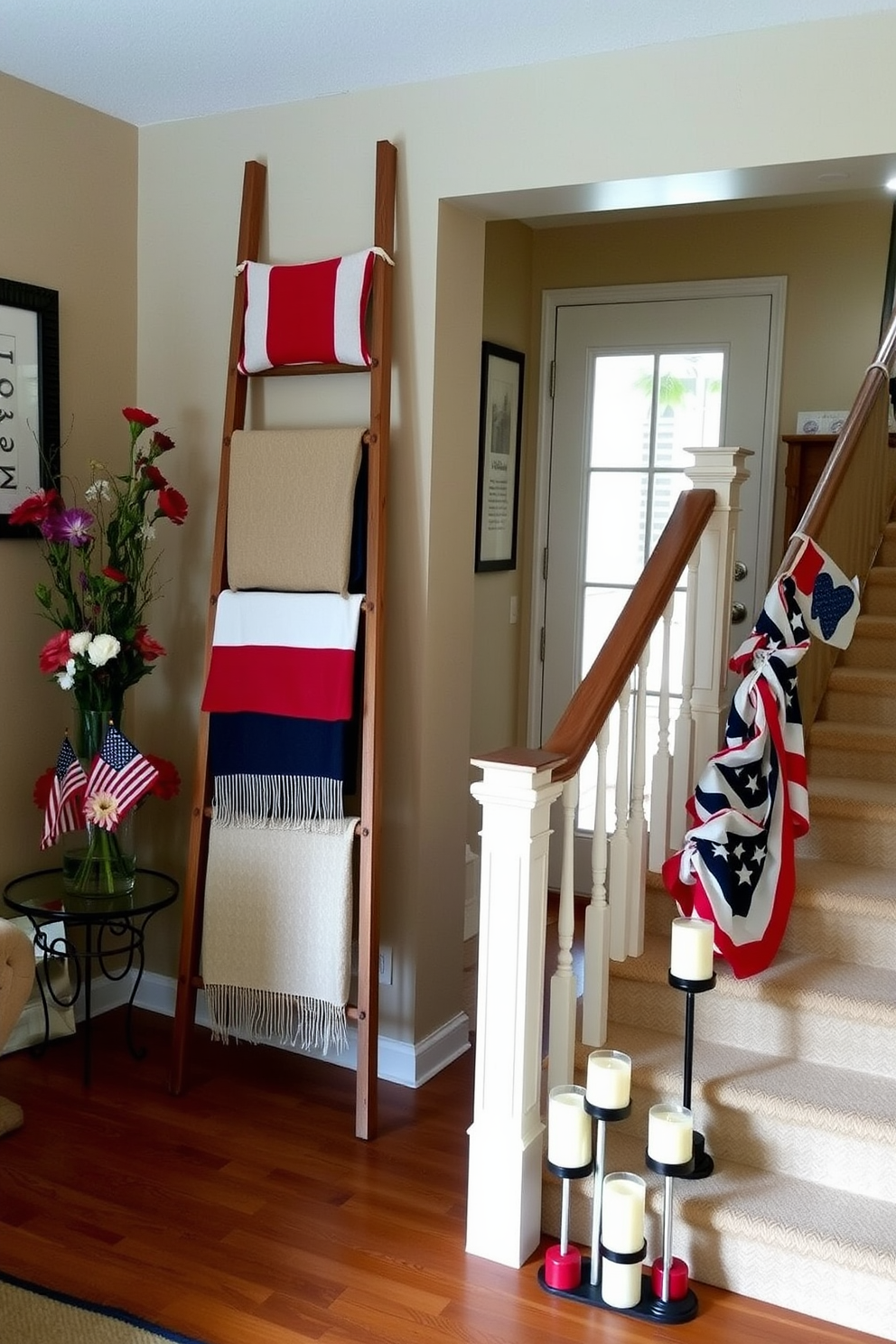 A cozy living room with a decorative wooden ladder leaning against the wall, adorned with blankets and pillows in red, white, and blue patterns. Next to the ladder, a small side table holds a vase filled with fresh flowers in patriotic colors, enhancing the festive ambiance. A grand staircase decorated for Memorial Day, featuring a garland of miniature flags draped along the railing. At the base of the stairs, a charming arrangement of candles in red, white, and blue holders creates a warm and welcoming entrance.