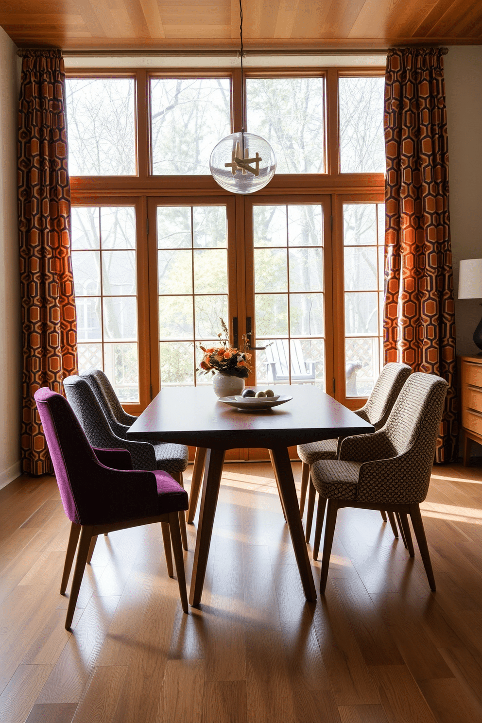 A Mid Century Modern dining room features a sleek wooden table with tapered legs, surrounded by colorful upholstered chairs that showcase textured fabrics. Large windows draped with flowing curtains in a bold geometric pattern allow natural light to illuminate the space, enhancing the warm wood tones and vibrant accents.