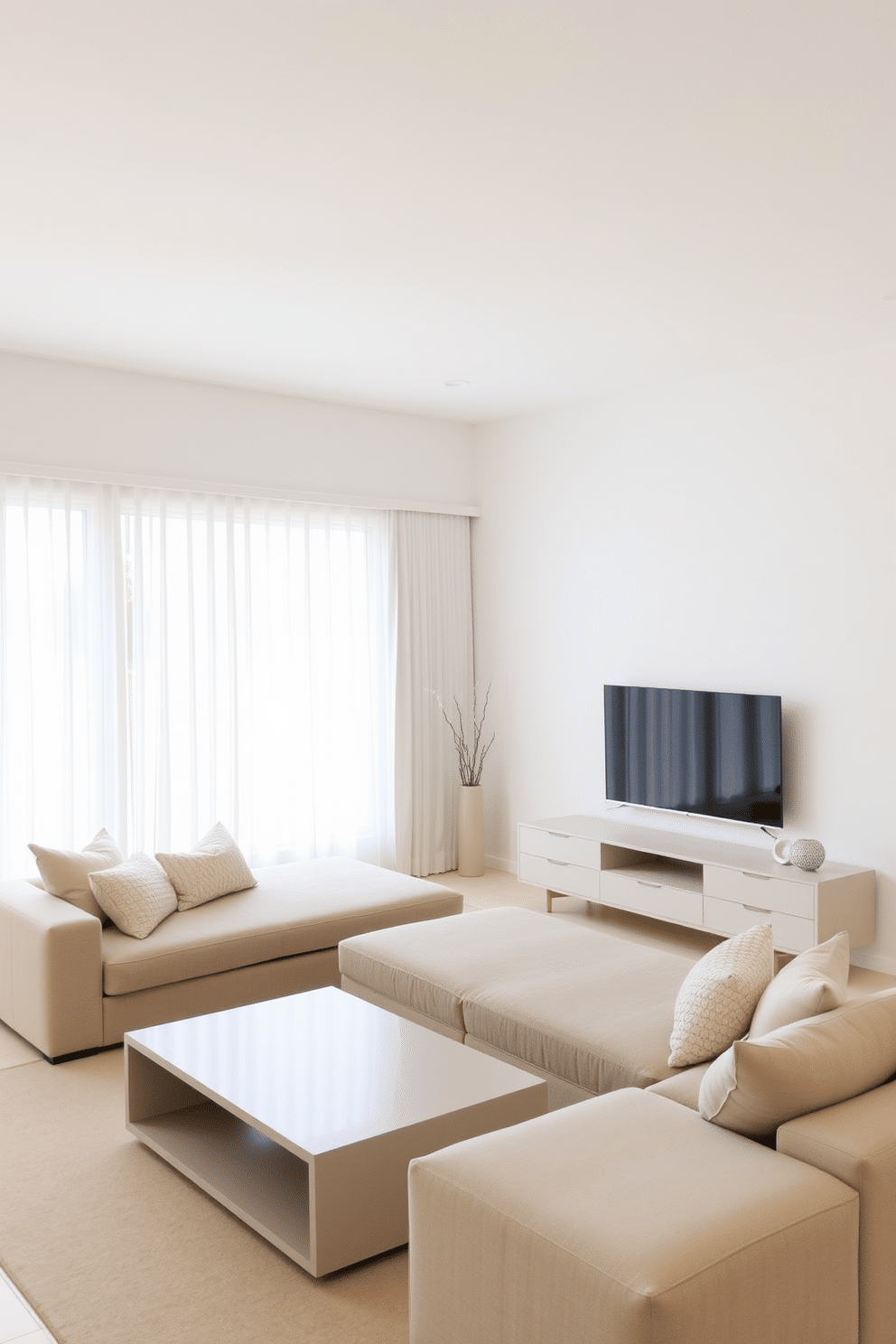 A minimalist family room with a neutral color palette. The space features a large, comfortable sectional sofa with soft, textured throw pillows, a low-profile coffee table, and a sleek entertainment unit. Simple window treatments that enhance the clean aesthetic of the room. Sheer white curtains frame the windows, allowing natural light to filter in while maintaining privacy.