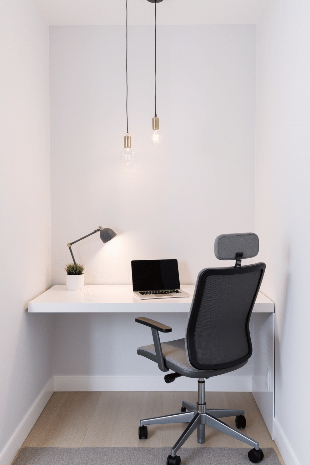 A minimalist home office features a sleek, white desk positioned against a light gray wall, complemented by a comfortable ergonomic chair in soft fabric. Simple pendant lights hang from the ceiling, casting a warm glow over the workspace, while a small potted plant adds a touch of greenery to the decor.