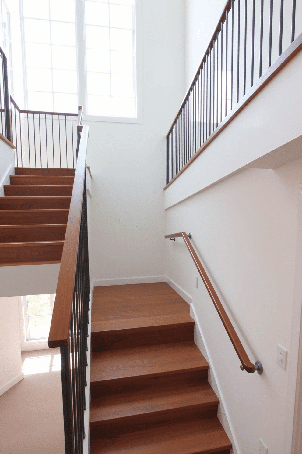 A striking staircase features wide steps crafted from rich hardwood, seamlessly leading to the upper level. The sleek, minimalist metal balusters provide a contemporary contrast, enhancing the open and airy feel of the space. Natural light pours in from large windows, illuminating the staircase and highlighting the clean lines of the design. The surrounding walls are painted in a soft white, creating a harmonious backdrop that emphasizes the staircase's elegant simplicity.