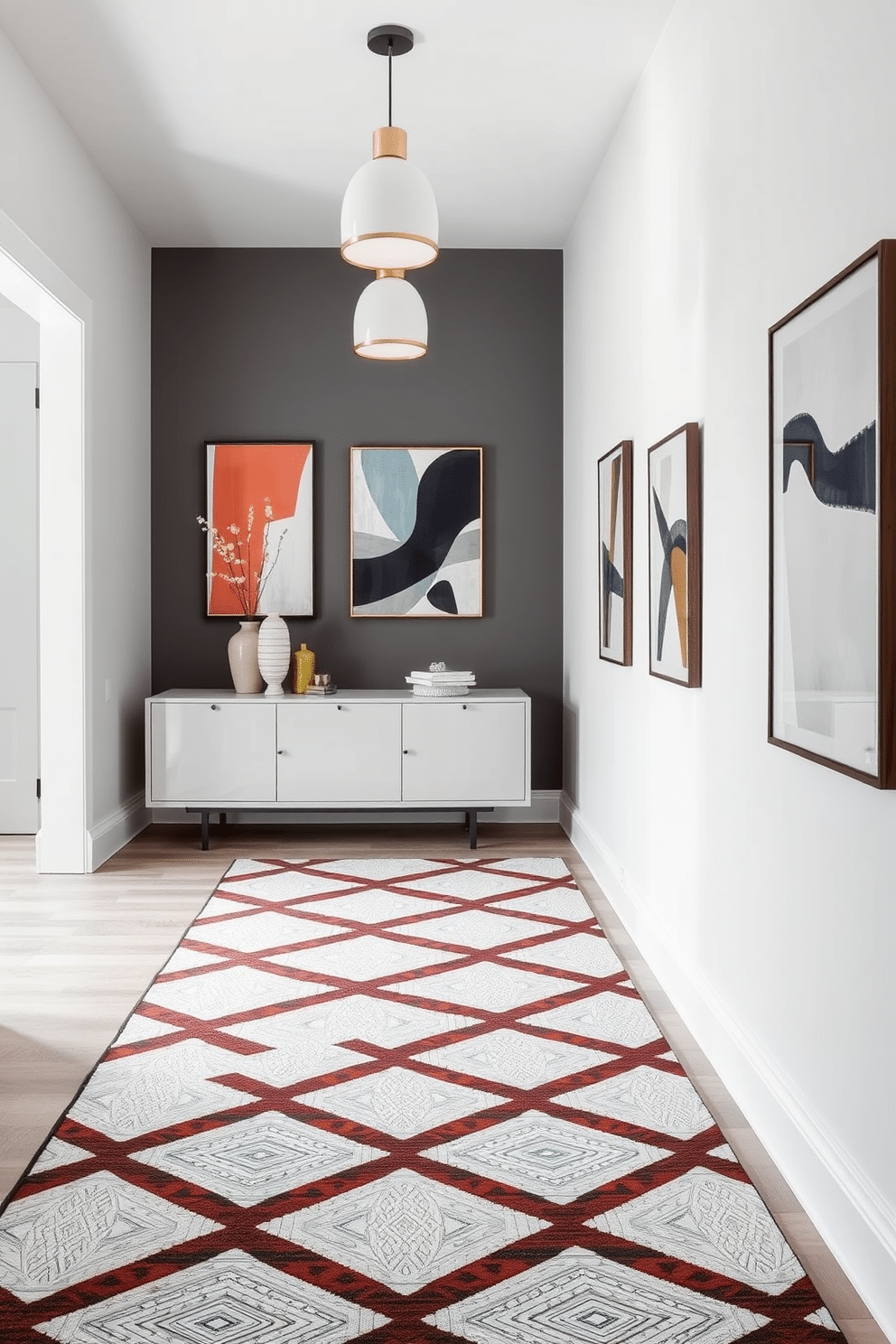 A modern entryway features a striking geometric patterned rug that adds a bold touch to the space. The walls are adorned with contemporary art pieces that echo the rug's design, creating a cohesive and inviting atmosphere. The entryway is illuminated by sleek pendant lighting that enhances the modern aesthetic. A minimalist console table with clean lines sits against the wall, topped with decorative objects that complement the overall design.