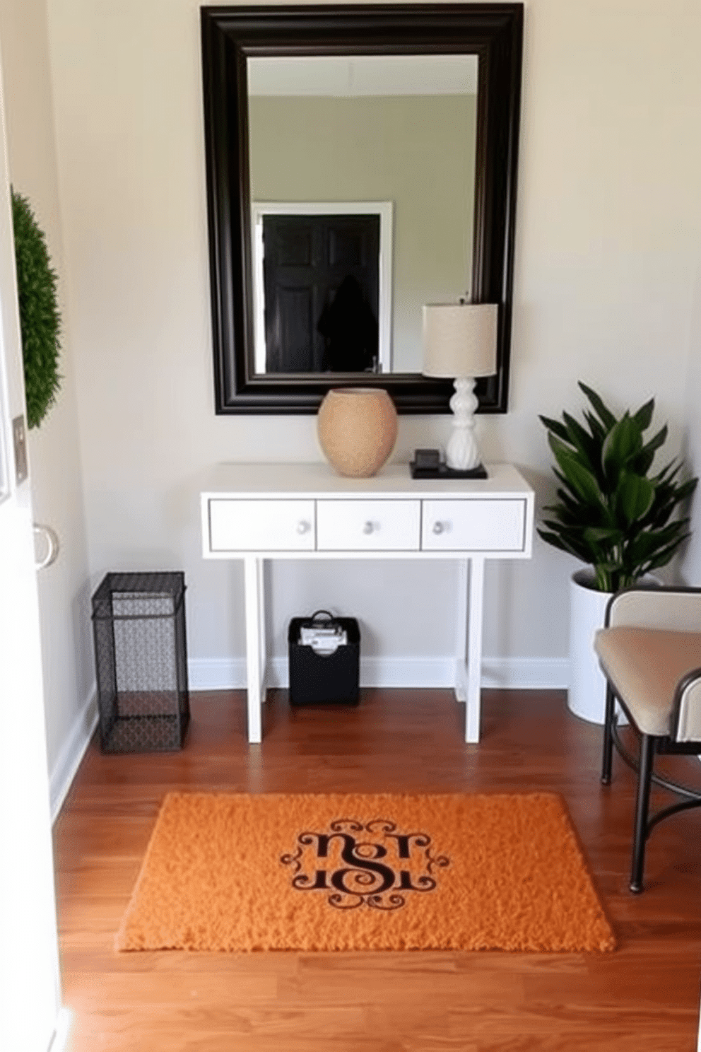 A welcoming doormat adorned with a personalized monogram sits at the entrance, inviting guests into a stylish space. The entryway features sleek, minimalist furniture, including a small console table with a decorative lamp and a vibrant plant to add a touch of greenery. The walls are painted in a soft, neutral tone, creating a warm and inviting atmosphere. A large mirror above the console table reflects natural light, enhancing the overall brightness of the entryway.