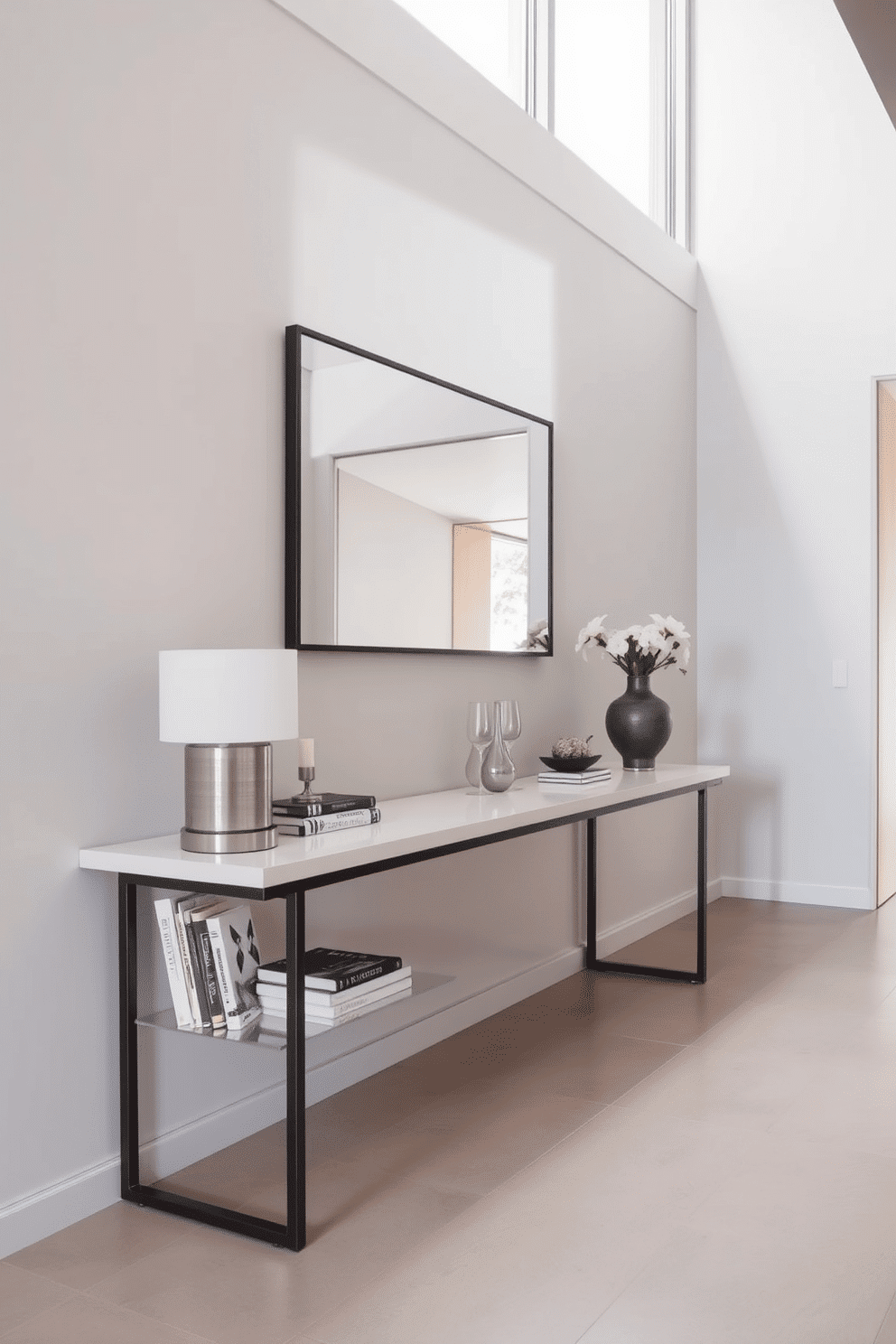 A sleek console table stands against the wall, showcasing a collection of decorative accents including a stylish lamp and a few art books. The foyer features a minimalist design with a neutral color palette, highlighted by a large mirror that reflects natural light.