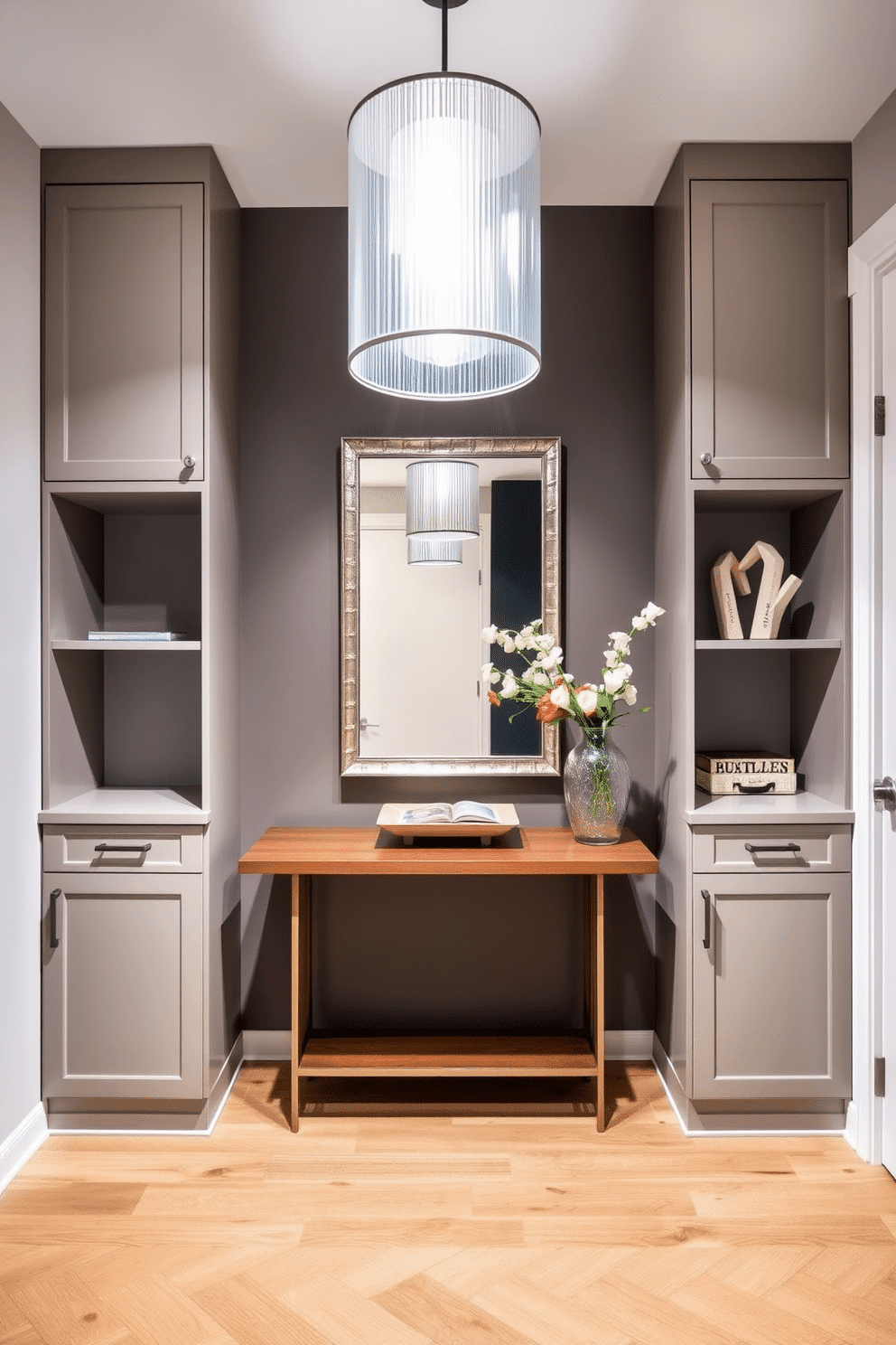 Custom built-ins for tailored storage. The design features sleek cabinetry with integrated shelving, providing a seamless look that maximizes space efficiency. Modern foyer design ideas. The entrance showcases a minimalist console table paired with a statement mirror, accented by a stylish pendant light that creates an inviting atmosphere.