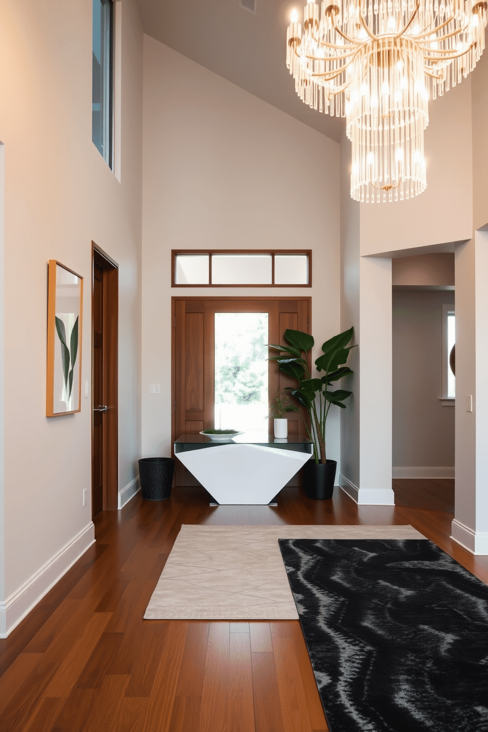 A modern foyer with an open layout that invites natural light, featuring a sleek console table with a geometric design. The walls are adorned with minimalist artwork, and a large potted plant adds a touch of greenery to the space. The flooring consists of polished hardwood, complemented by a stylish area rug that defines the entryway. A statement chandelier hangs from the ceiling, creating an elegant focal point while enhancing the spacious feel of the foyer.