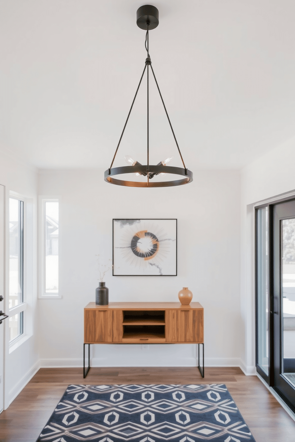 A stylish pendant light hangs gracefully from the ceiling, featuring a sleek design with a matte black finish and warm, dimmable LED bulbs. Below it, a minimalist console table in natural wood complements the light, adorned with a few carefully curated decorative items. The modern foyer design showcases an open space with large windows that allow natural light to flood in, enhancing the airy atmosphere. A geometric-patterned area rug anchors the space, while a statement wall art piece adds a pop of color and personality.