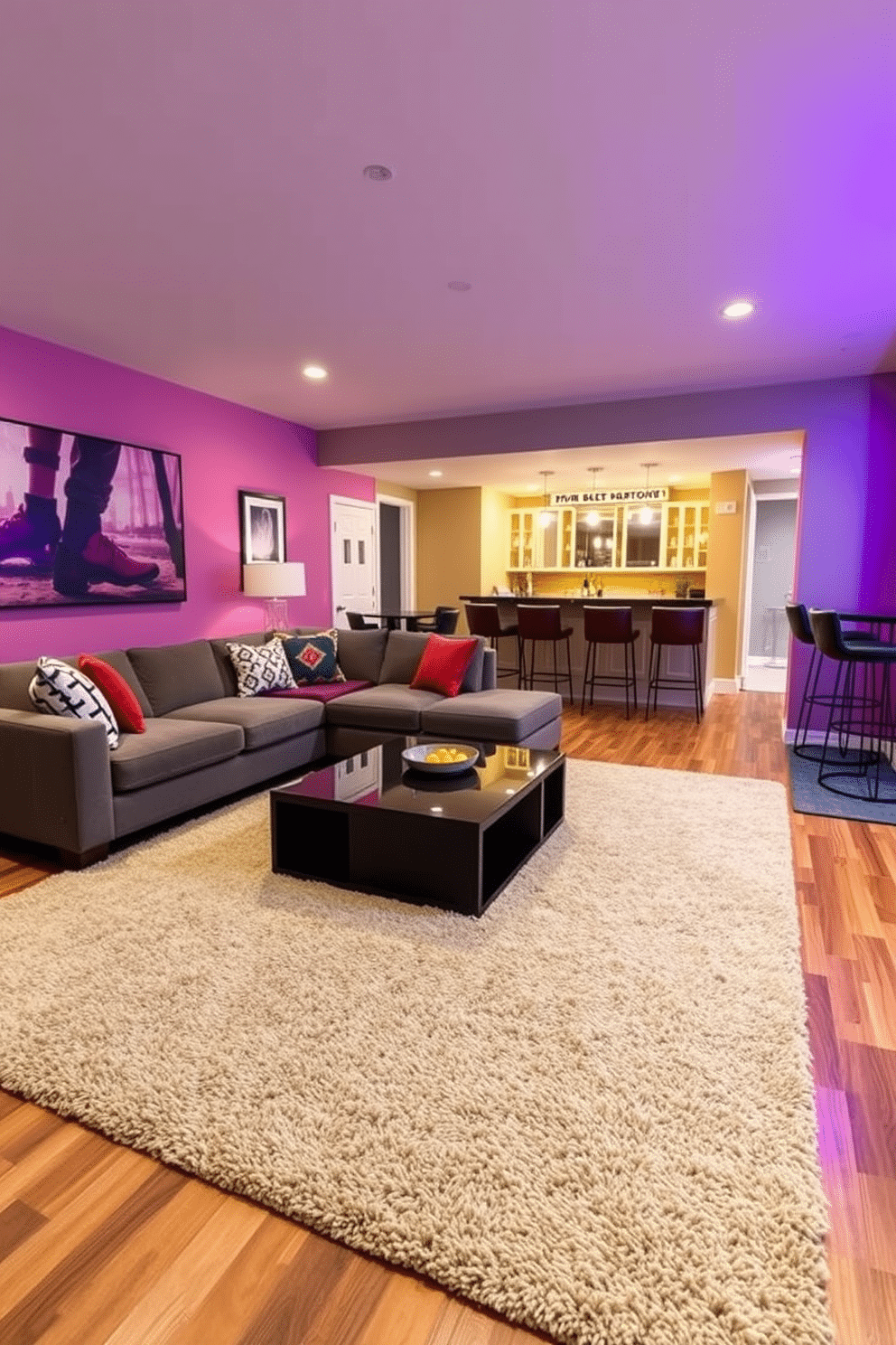 A cozy game room featuring a large, plush textured rug that adds warmth and comfort underfoot. The rug is layered over hardwood flooring, complementing a sectional sofa and a sleek coffee table in the center of the space. A modern game room designed with a mix of vibrant colors and contemporary furniture. The walls are adorned with framed artwork, and a stylish bar area is set up in one corner, complete with high stools and ambient lighting.