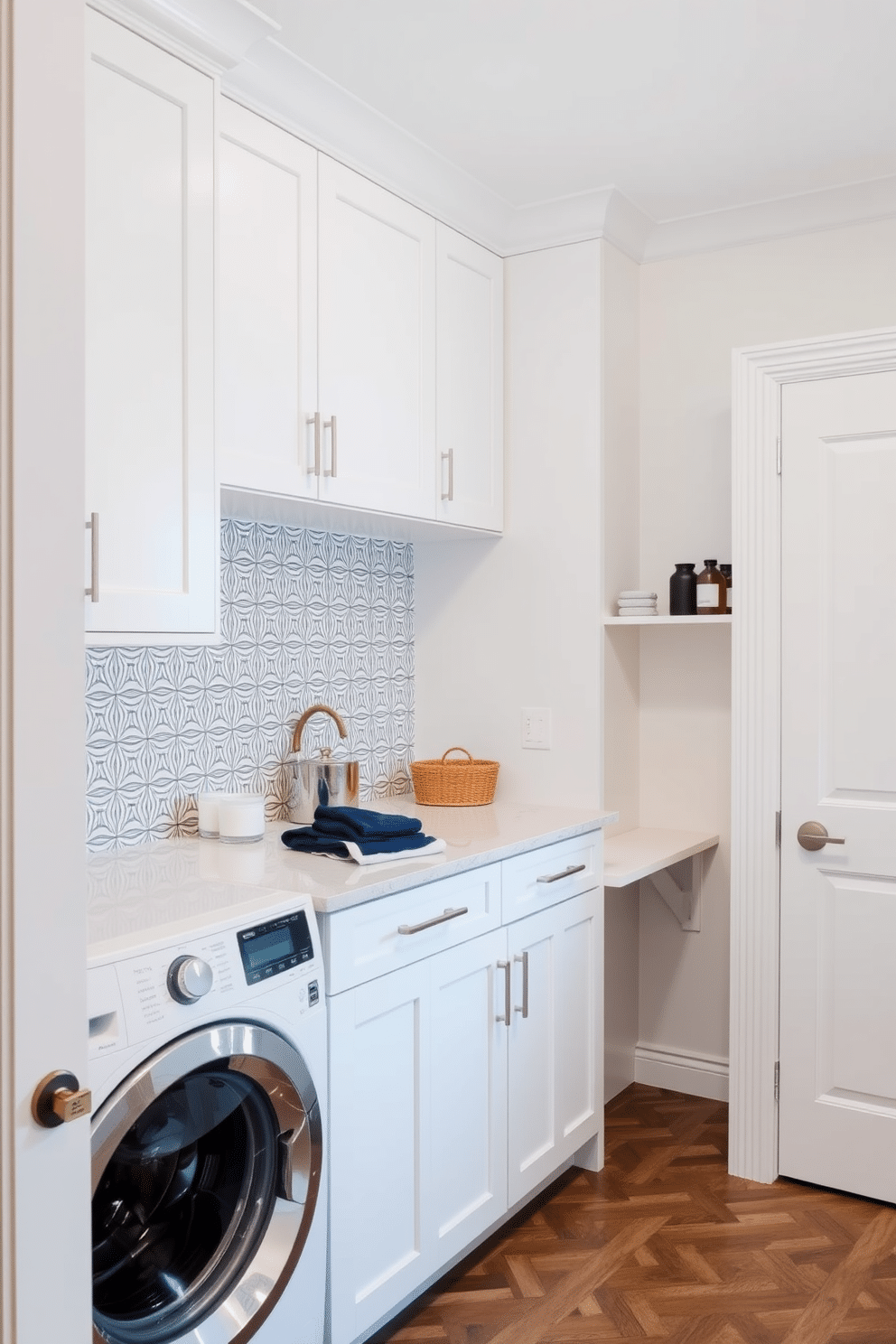 A chic laundry room featuring a sleek, minimalist design with a small desk tucked into one corner. The cabinetry is a soft white, complemented by a stylish backsplash in a geometric pattern, while the countertop offers ample space for folding clothes and organizing supplies.