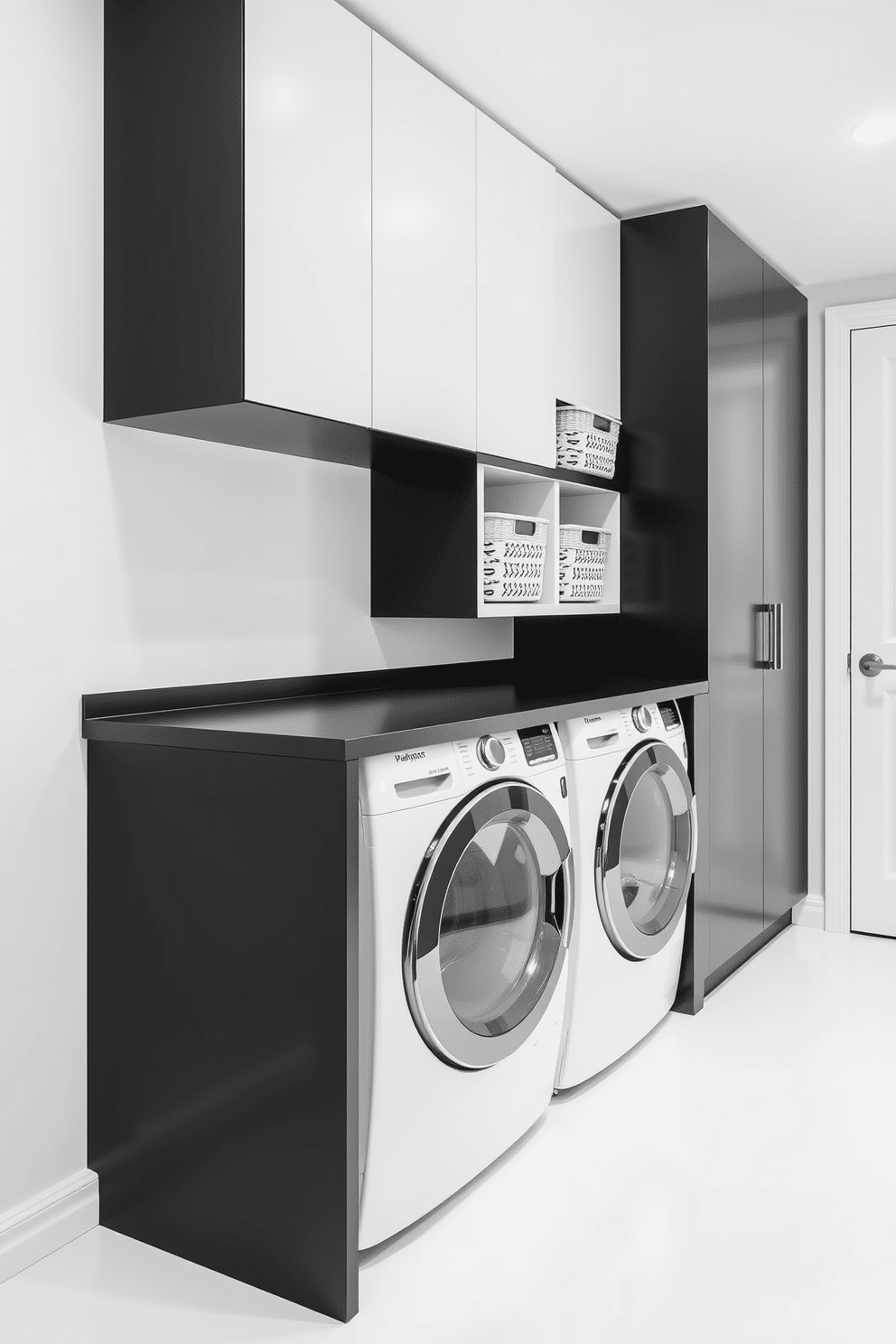 A sleek and functional laundry room featuring a minimalist black and white color scheme. The walls are painted crisp white, while the cabinetry is matte black, providing a striking contrast. The space includes a large, modern washer and dryer seamlessly integrated into the cabinetry. A simple black countertop extends over the machines, with a few neatly arranged storage baskets in varying sizes for organization.