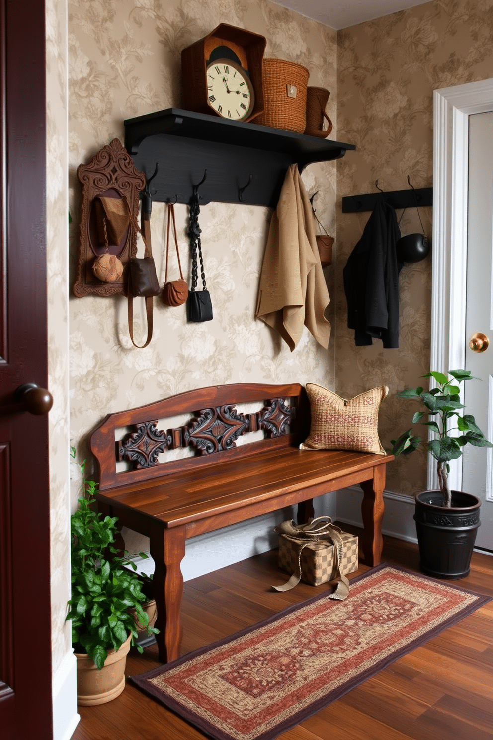 A stylish mudroom featuring vintage accents that add a unique touch. The space includes a rustic wooden bench with intricate carvings, complemented by a collection of antique hooks for hanging coats and bags. The walls are adorned with a muted floral wallpaper, creating a warm and inviting atmosphere. A patterned area rug lies on the floor, while potted plants bring a touch of greenery to the design.