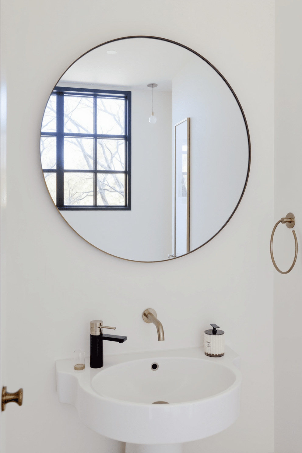 A modern powder room featuring a large round mirror that reflects abundant natural light, enhancing the sense of space. The walls are adorned with soft, neutral tones, complemented by sleek, minimalist fixtures and elegant accessories.