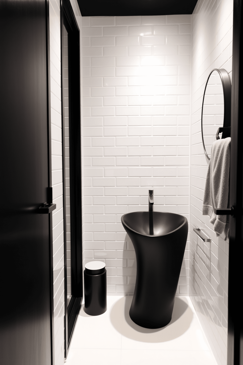 A minimalist powder room features sleek white tiles that create a clean and airy atmosphere. Bold, modern fixtures, such as a striking black faucet and a sculptural vanity, add a touch of drama and sophistication to the space.