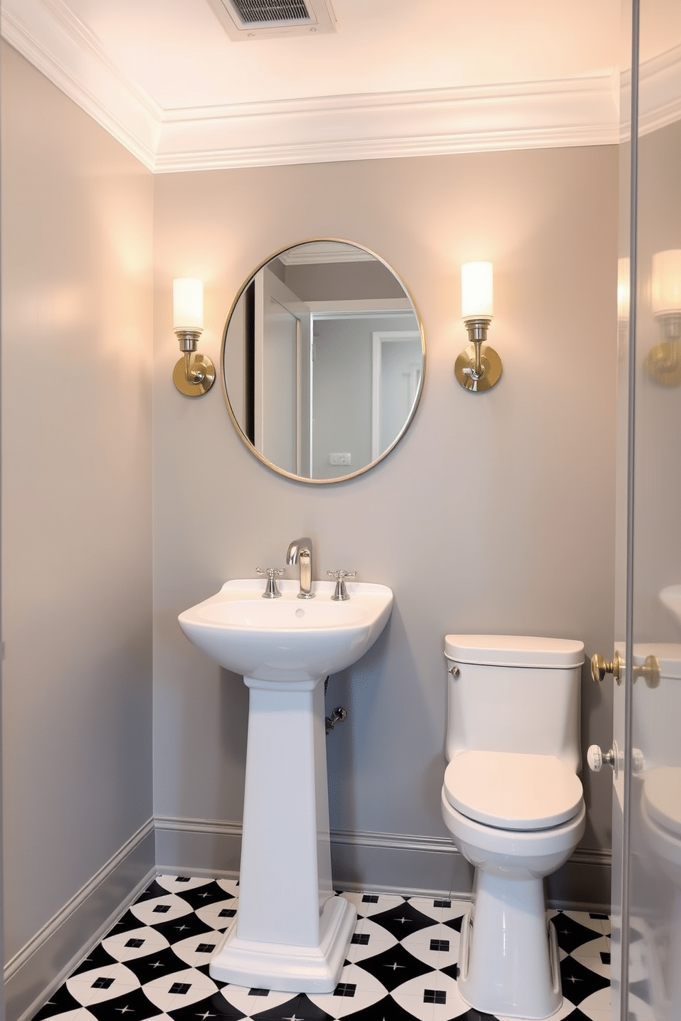 A modern powder room featuring elegant sconces flanking a large, round mirror. The walls are painted in a soft gray, complemented by a sleek white pedestal sink and a stylish black and white tile floor.