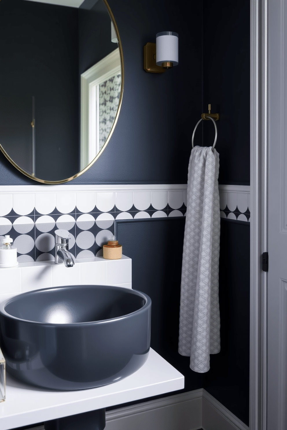 A moody powder room featuring a striking graphite sink paired with a sleek, modern faucet. The walls are adorned with deep navy paint, complemented by a chic black and white geometric wallpaper accent.