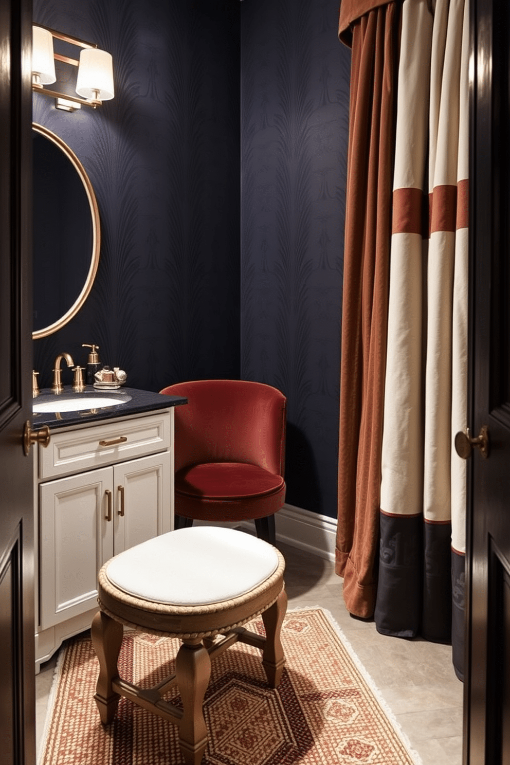 A moody powder room featuring rich textures and layered fabrics. The walls are adorned with deep navy wallpaper, while a plush velvet chair in a contrasting color sits elegantly in the corner. The countertop is a stunning black marble with gold veining, complemented by a sleek, modern sink. Ambient lighting casts a warm glow, highlighting the intricate details of a textured area rug beneath a vintage wooden stool.