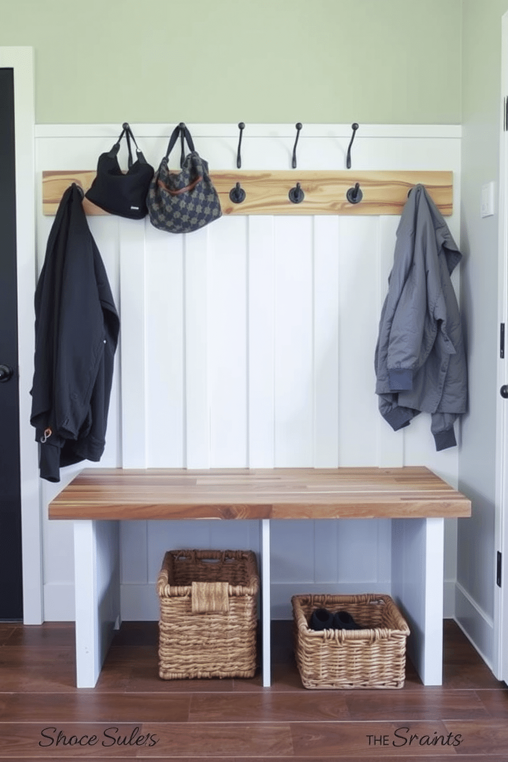 A stylish mudroom features a multi-functional bench with foldable seating, crafted from reclaimed wood for a rustic charm. Above the bench, hooks are mounted on the wall for hanging coats and bags, while a woven basket sits underneath for storing shoes and outdoor gear.