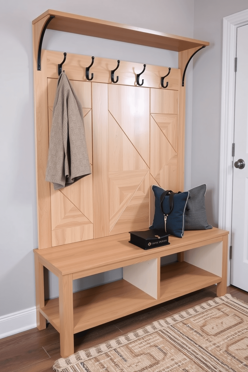 A contemporary mudroom bench features a sleek design with geometric patterns, crafted from a combination of light wood and metal accents. The bench is complemented by a series of hooks above for hanging jackets, while a textured rug in neutral tones lies beneath to add warmth and comfort.