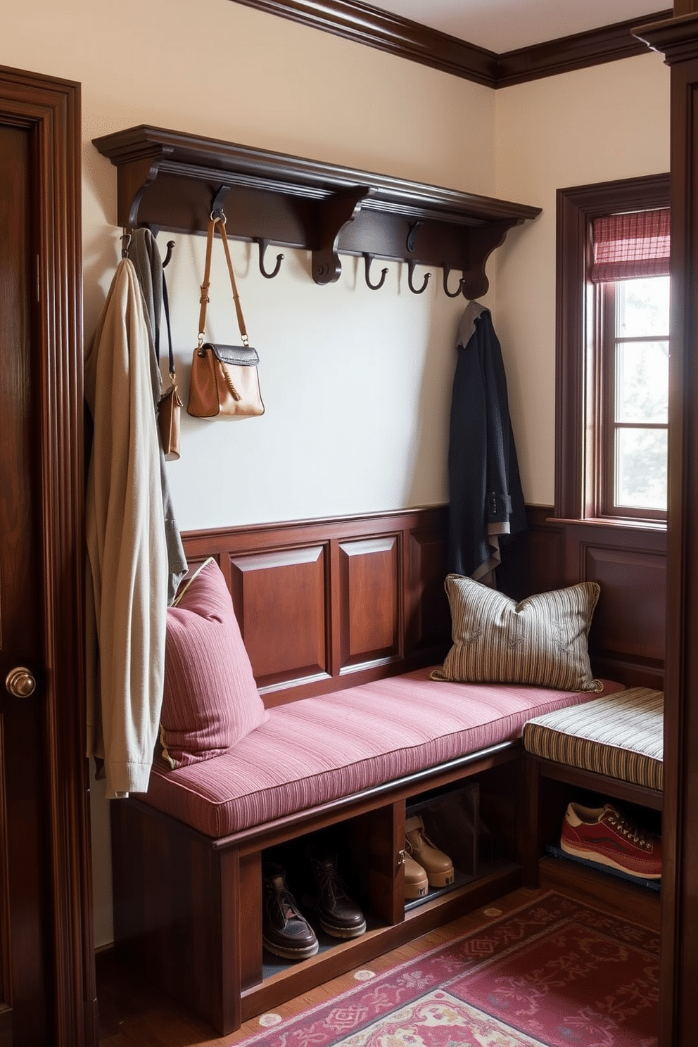 A traditional bench with classic upholstery is placed against the wall, featuring intricate woodwork and soft, inviting fabric in rich hues. Above the bench, a row of hooks provides a practical yet stylish solution for hanging coats and bags, while a decorative rug adds warmth to the space. The mudroom showcases a functional design with a built-in bench that doubles as storage, upholstered in durable, easy-to-clean fabric. Natural light floods the area through a nearby window, highlighting the bench's elegant details and the organized space for shoes and outdoor gear.