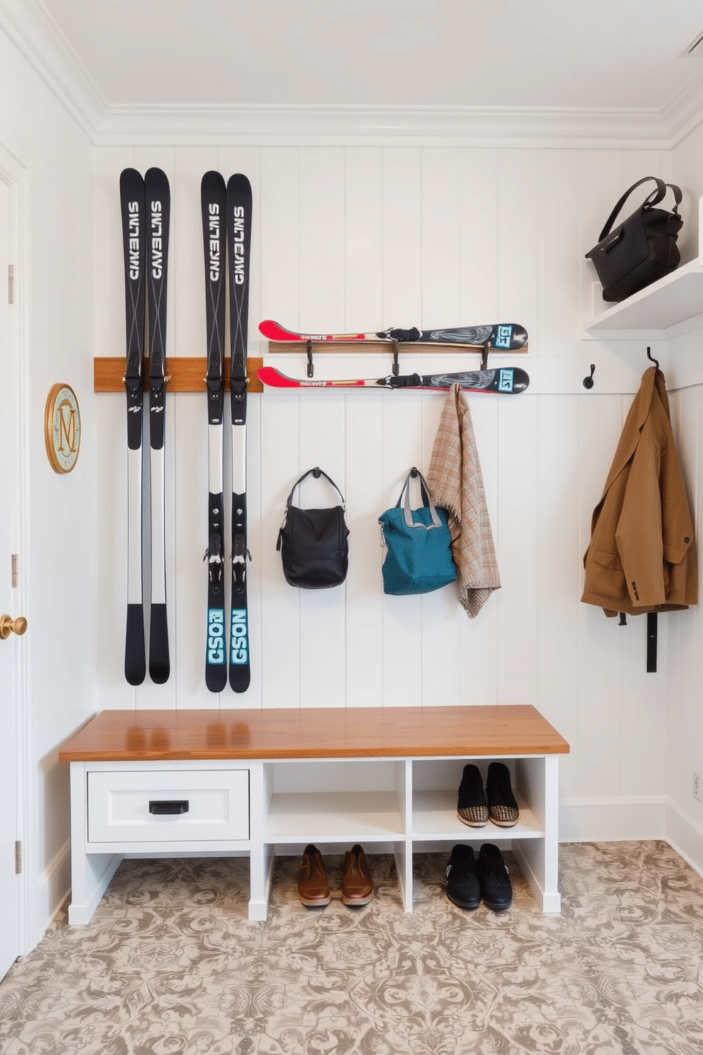 A stylish mudroom features vertical storage solutions designed specifically for long items like skis. The space is organized with a sleek, custom-built wooden rack that showcases the skis while keeping them easily accessible. The walls are painted a crisp white, creating a bright and airy atmosphere, while the floor is adorned with durable, patterned tiles that can withstand the elements. A bench with built-in cubbies provides a practical spot for changing shoes, complemented by hooks for jackets and bags above.