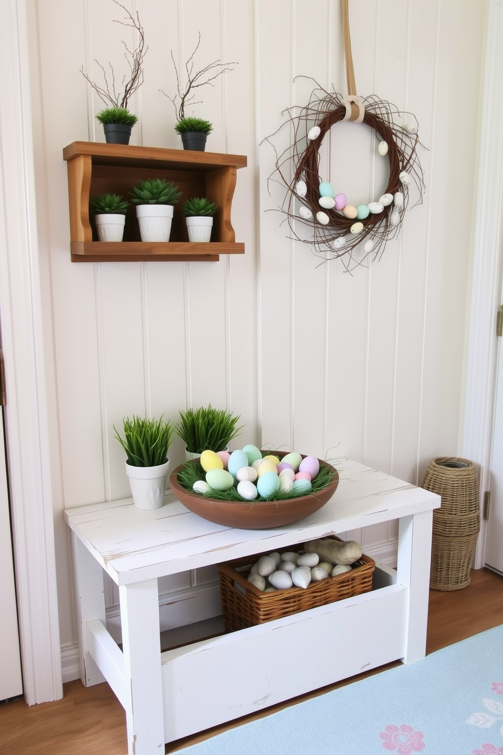 A cozy mudroom decorated for Easter. There are pastel-colored DIY painted eggs in a rustic wooden bowl placed on a whitewashed bench. Above the bench, a wooden shelf holds small potted plants and a wicker basket filled with faux grass and more painted eggs. The walls are a soft, creamy white, and a light blue rug with a floral pattern covers the floor. A wreath made of twigs and adorned with small pastel eggs hangs on the back of the door, adding a festive touch to the space.