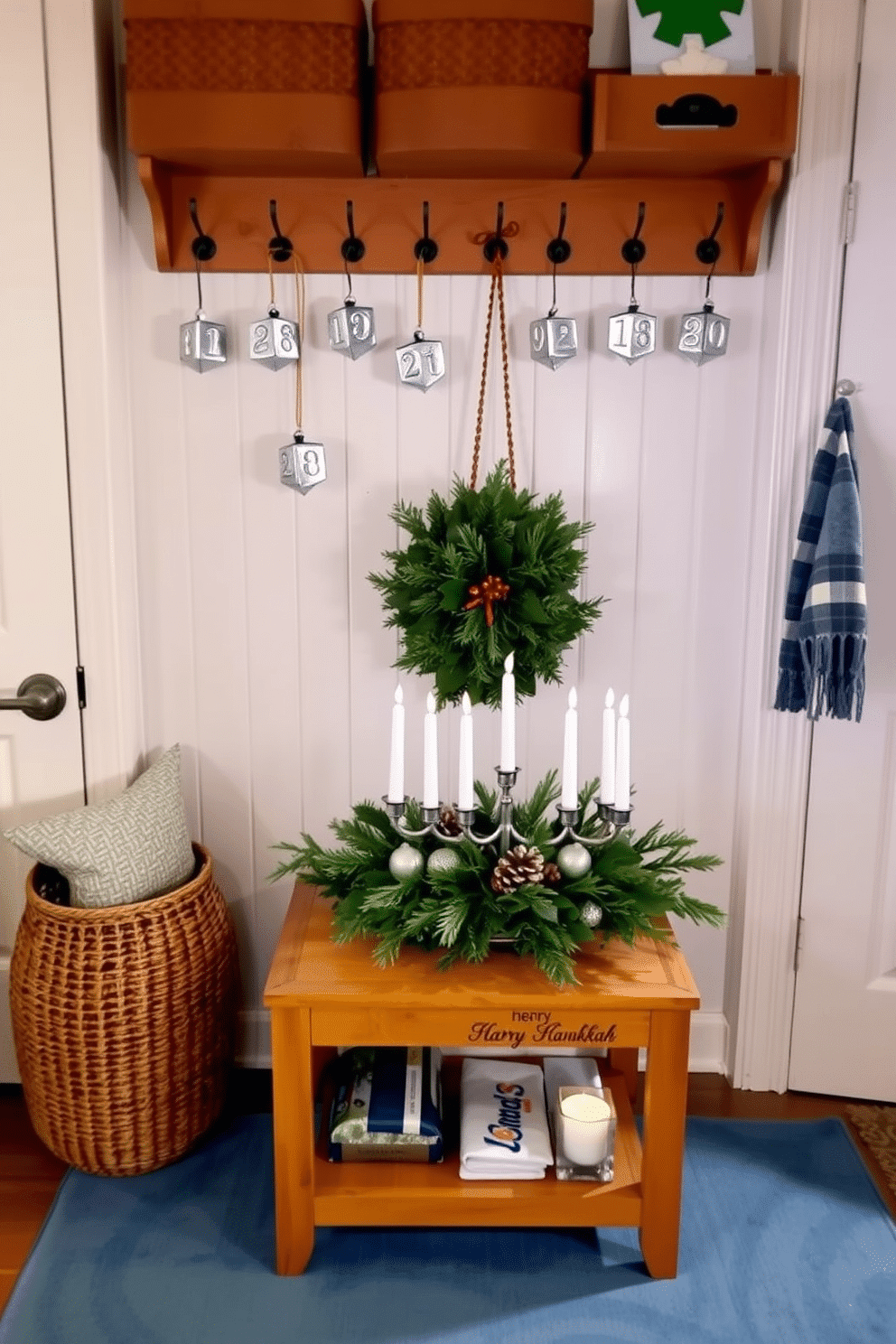 A cozy mudroom decorated for Hanukkah features silver dreidel ornaments hanging from hooks on the wall, adding a festive touch to the space. The floor is covered with a soft blue rug, and a small table displays a beautifully arranged menorah surrounded by candles and seasonal greenery.