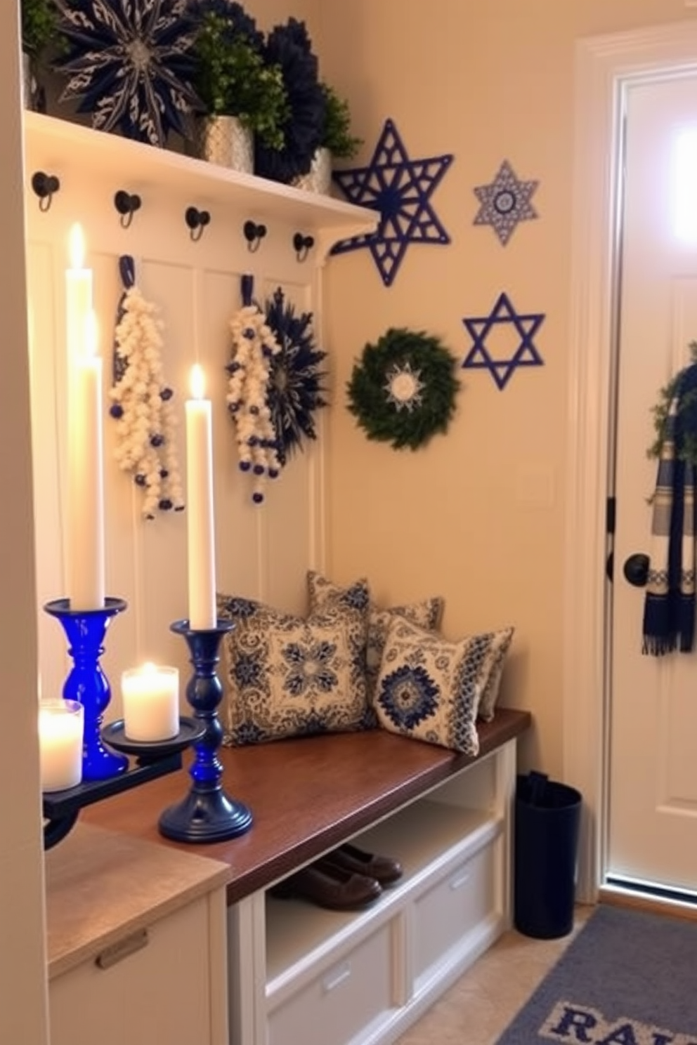 A serene mudroom decorated for Hanukkah features white candles placed in elegant blue holders, casting a warm and inviting glow. The walls are adorned with festive blue and white decorations, while a cozy bench provides a perfect spot for removing shoes, surrounded by decorative pillows in traditional patterns.