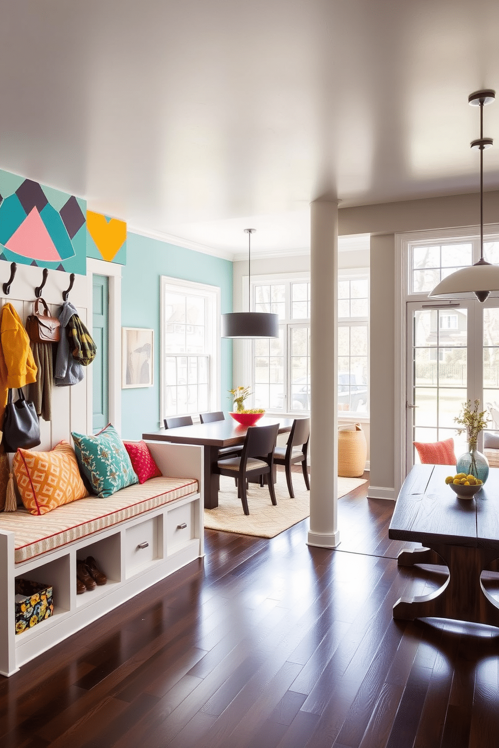 A vibrant accent wall in a mudroom features a bold geometric pattern with shades of teal, coral, and mustard yellow, creating a lively focal point. Complementing the wall, a sleek built-in bench with colorful cushions provides a welcoming seating area, while hooks above hold an array of stylish coats and bags. Adjacent to the dining room, the mudroom boasts a functional layout with a rustic wooden table for storage and display. Large windows allow natural light to flood the space, enhancing the cheerful atmosphere and connecting it seamlessly to the dining area.