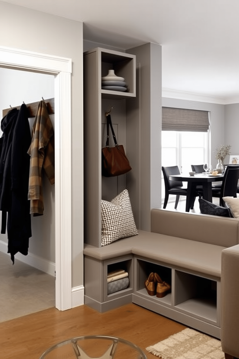 A stylish mudroom adjacent to the dining room features a built-in bench with storage underneath, adorned with plush cushions for comfort. The walls are painted a soft gray, and hooks for coats and bags are neatly arranged above the bench, creating an organized and inviting space. Incorporate multi-functional furniture pieces, such as an expandable dining table that can accommodate guests while also serving as a workspace. A sleek sofa bed in the living area allows for easy transformation from a seating area to an extra sleeping space, maximizing the room's utility.