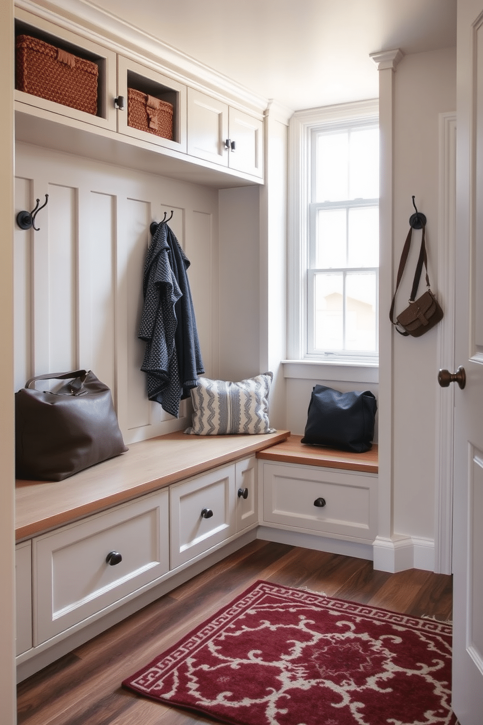 A mudroom design that seamlessly integrates hidden storage behind faux drawers, creating a clean and organized space. The room features a combination of built-in benches and cabinetry, with a neutral color palette that enhances the inviting atmosphere. Natural light floods the area through a nearby window, illuminating the durable flooring that withstands daily wear. Decorative hooks line the walls for easy access to coats and bags, while a stylish area rug adds a touch of warmth and comfort.