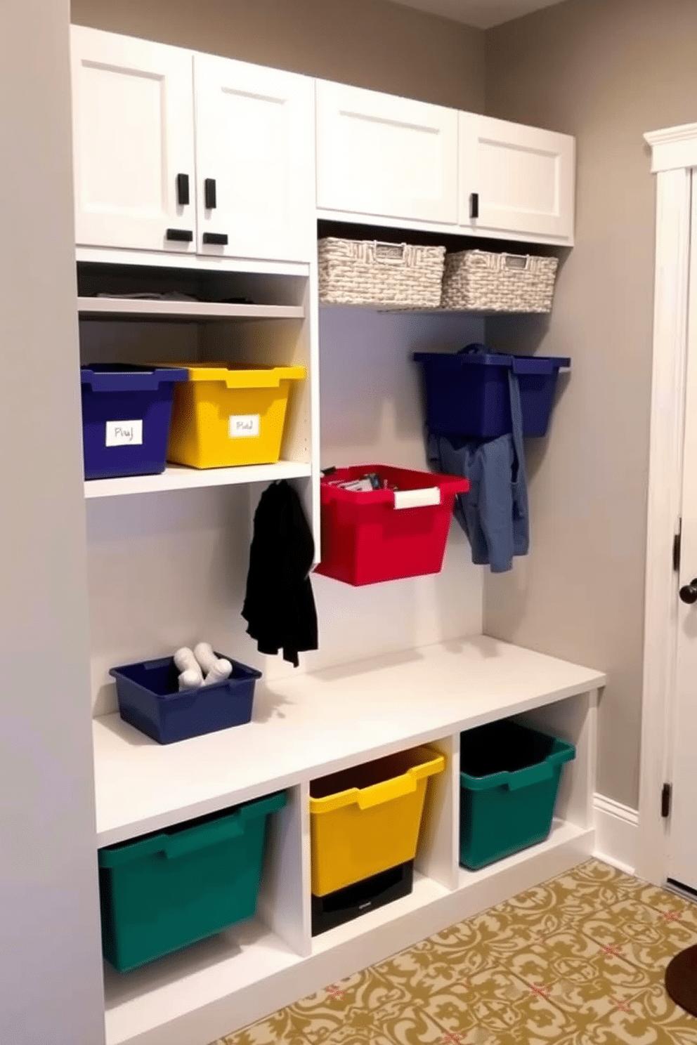 A stylish mudroom adjacent to the family room features a series of color-coordinated bins for organization, neatly arranged on built-in shelves. The walls are painted a soft gray, while the floor is adorned with durable, patterned tiles that complement the bins' colors.