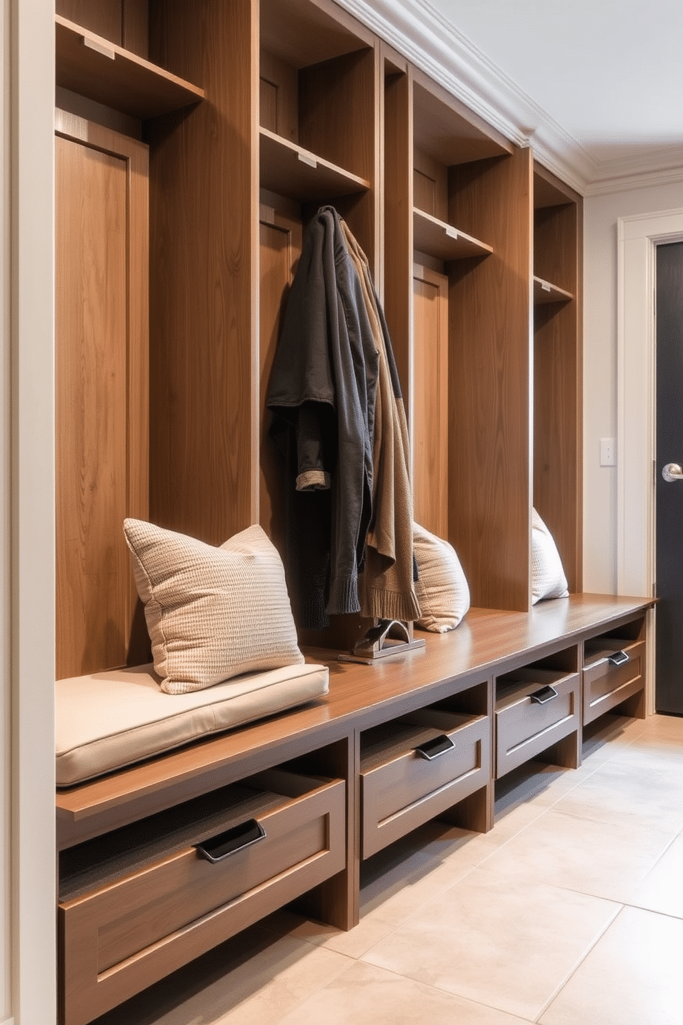 A stylish mudroom near the garage features built-in benches with soft cushions, providing a comfortable spot to sit while removing shoes. Below the benches, spacious storage drawers are seamlessly integrated, perfect for stowing away outdoor gear and keeping the area organized.