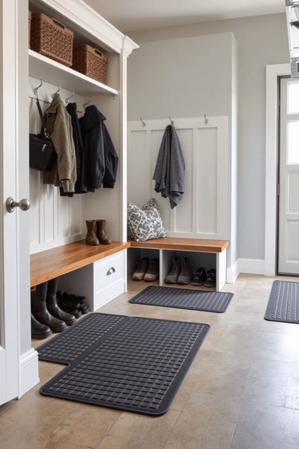 A functional mudroom near the garage features durable floor mats designed for effective mud and dirt control. The space includes built-in storage for shoes and coats, with a bench for convenience and easy access.