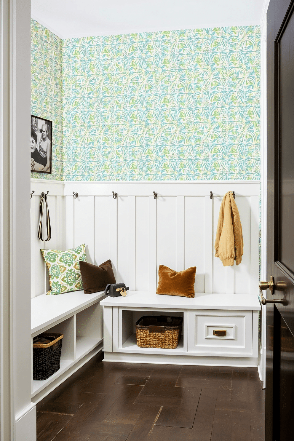 A stylish mudroom adjacent to the kitchen features an accent wall adorned with vibrant patterned wallpaper, creating a focal point that adds character to the space. The room includes built-in storage benches, hooks for coats, and a durable floor that withstands heavy foot traffic, blending functionality with aesthetic appeal.