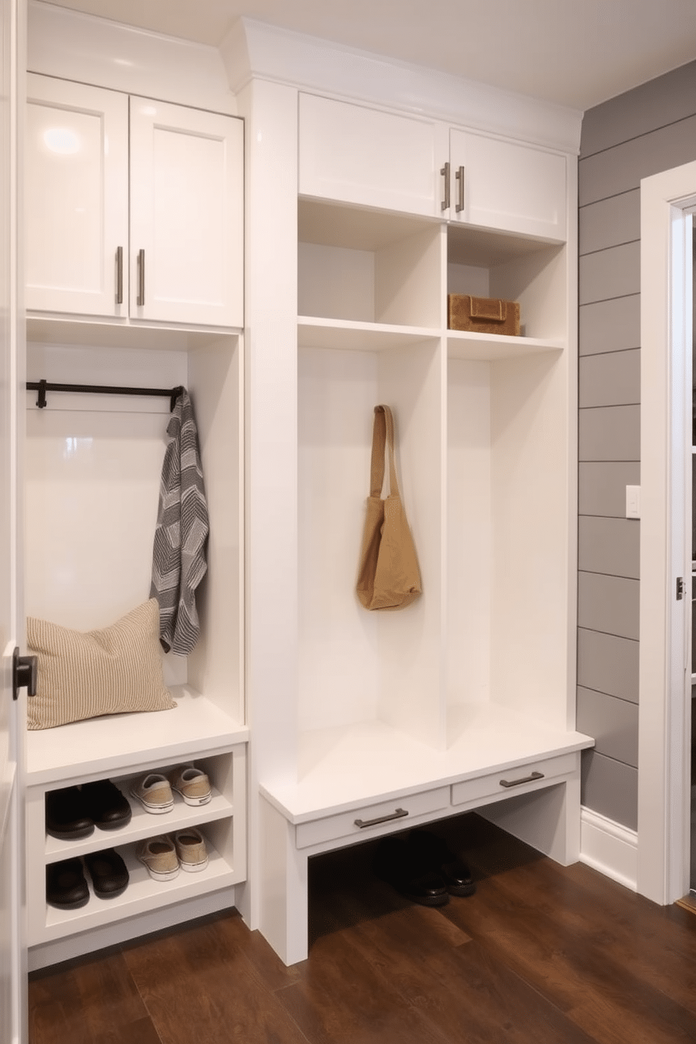 A mudroom adjacent to the kitchen features sleek cabinetry with a glossy white finish, providing ample storage for shoes and outerwear. The space includes built-in benches with plush cushions, and the walls are adorned with subtle gray shiplap to enhance the modern aesthetic.