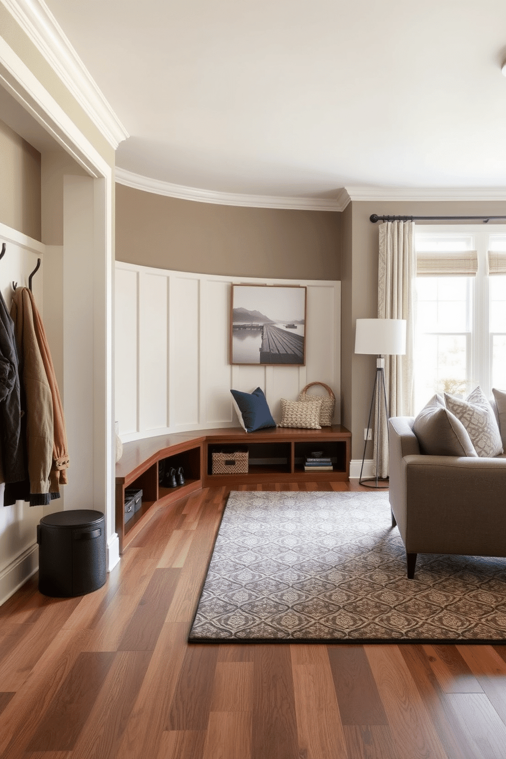 A mudroom designed for high traffic areas features durable flooring that withstands wear and tear. The space includes built-in benches with storage underneath, hooks for coats, and a large area rug to add warmth and texture. Adjacent to the living room, the mudroom transitions seamlessly with a cohesive color palette. Natural light floods the area through a nearby window, highlighting the functional yet stylish design elements.