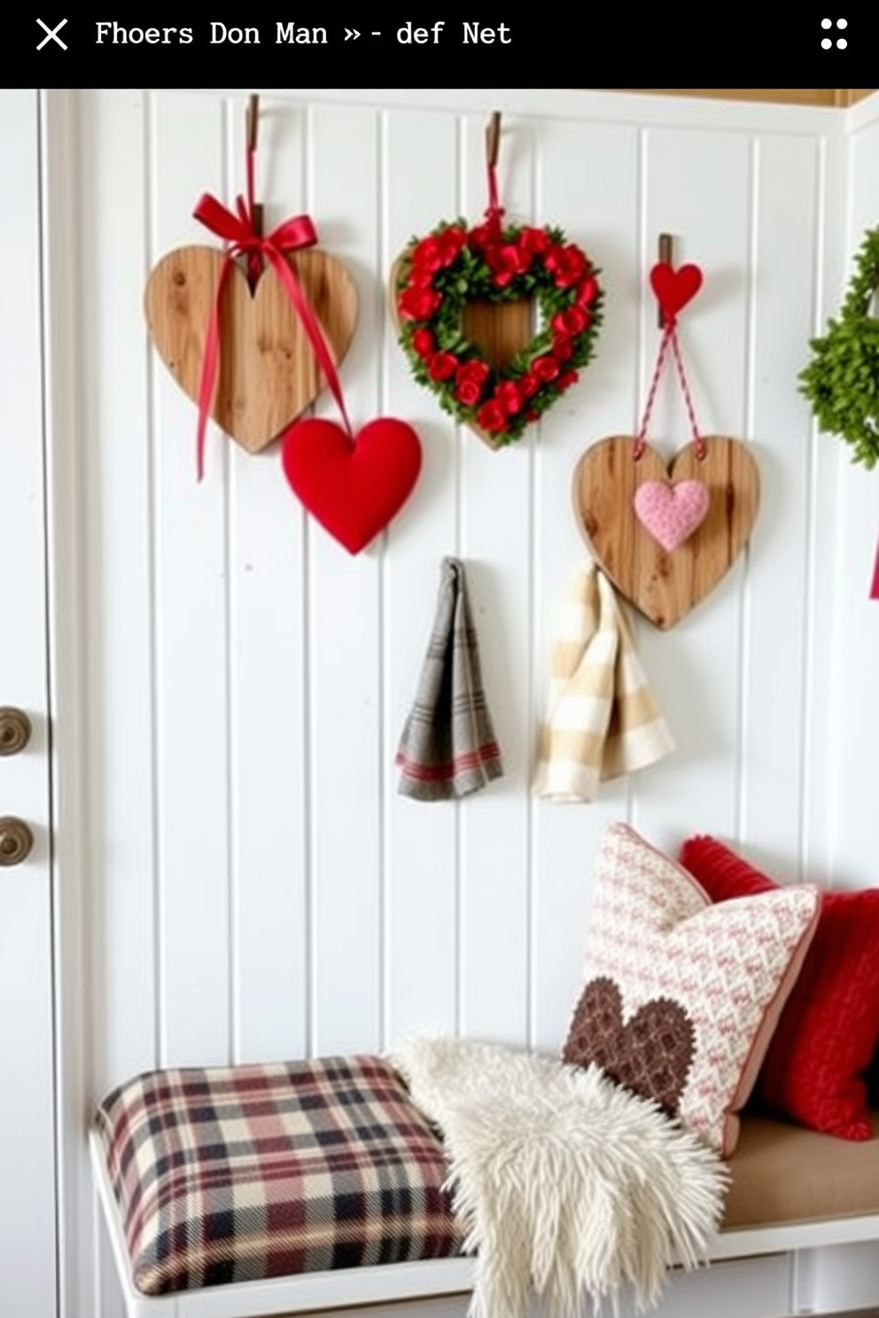 A charming mudroom decorated for Valentine's Day features heart-shaped door hangers made from rustic wood, adorned with red and pink accents. The space is enhanced with cozy textiles, including a plaid bench cushion and throw pillows, creating a warm and inviting atmosphere.