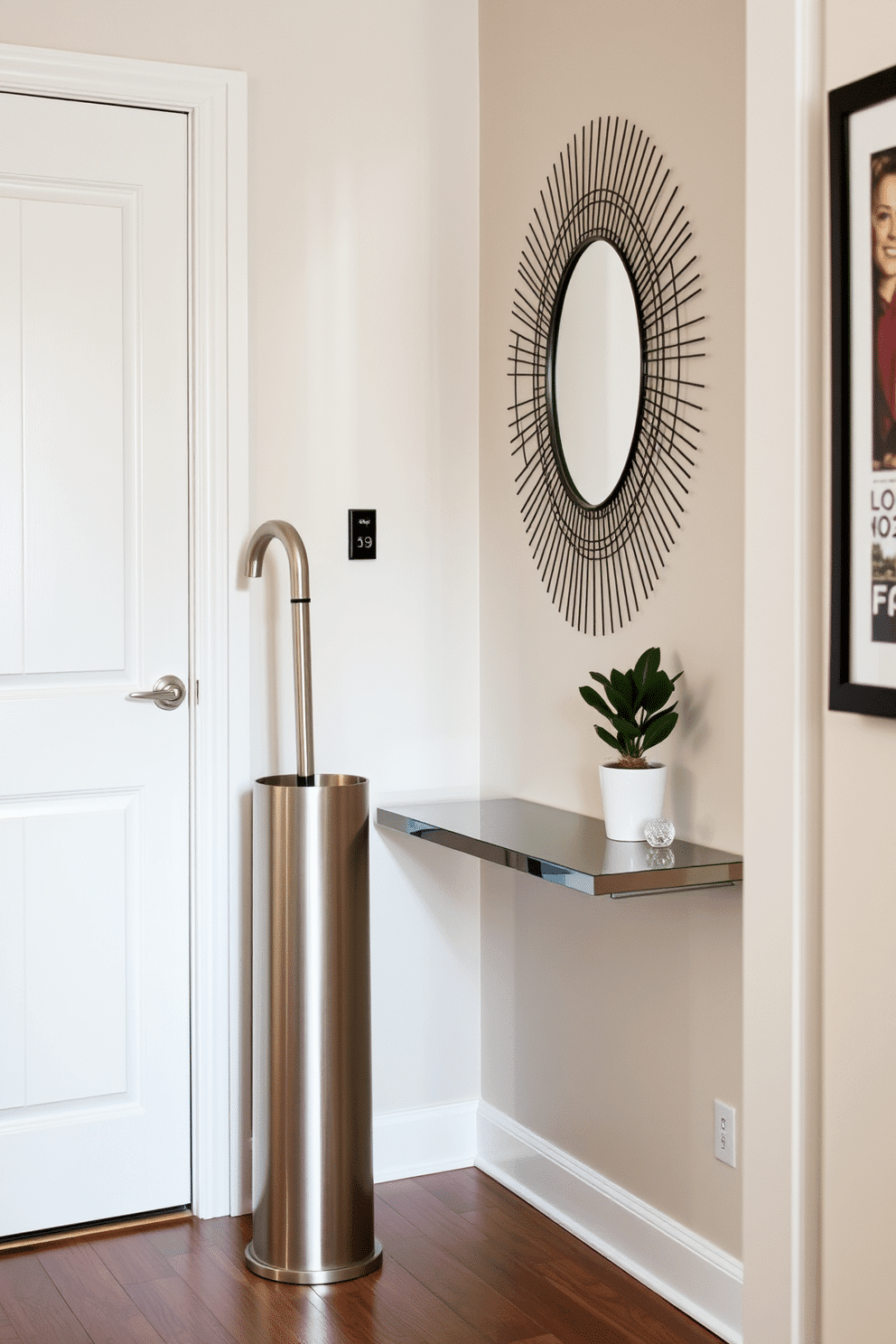 A stylish umbrella stand made of brushed stainless steel is positioned elegantly near the door, adding a modern touch to the entryway. The narrow entryway features a sleek console table against the wall, adorned with a small potted plant and a decorative mirror that enhances the sense of space.